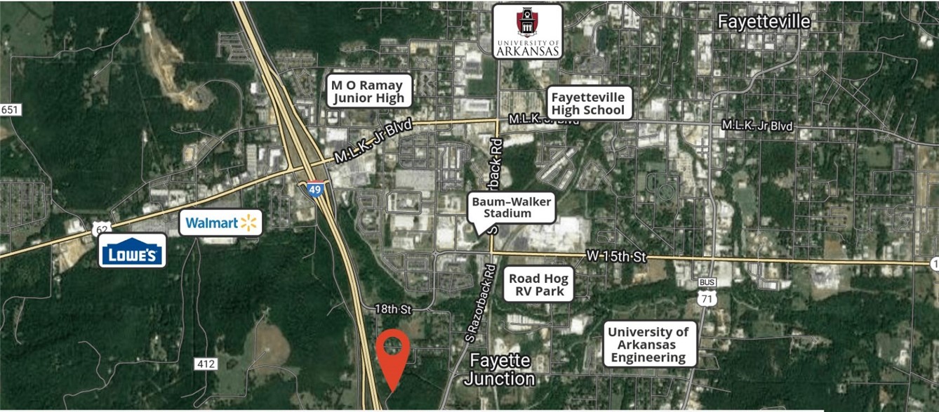 Prime real estate with visibility from northbound I-49. Excellent multi-family development opportunity. Near the University of Arkansas, adjacent to the CATO Springs Research Center, & south of Baum Walker Stadium. Easy access to I-49 & W MLK Jr Blvd via S Razorback Rd. Approx. 357' along I-49. Partially cleared. Water onsite, sewer access near interstate. RMF-24 zoning. Rental property provides immediate income stream. Close to Fayetteville's top amenities.