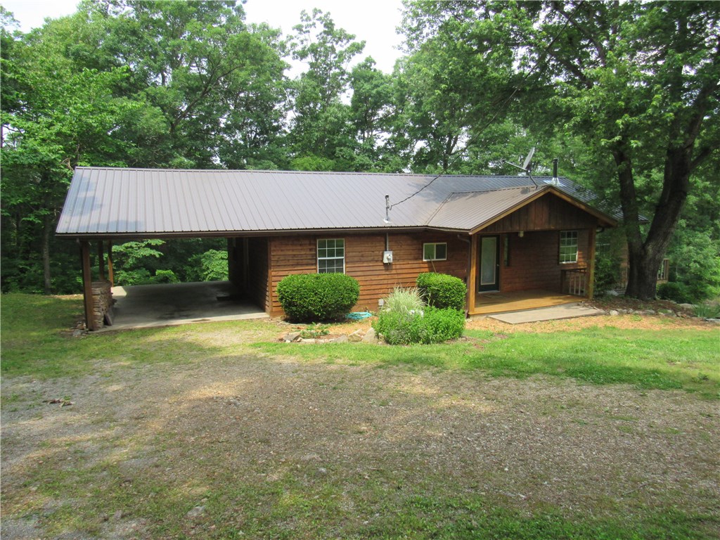 Very affordable great 3 bedroom 2 bath home in the country and just minutes to Eureka Springs proper.  Cedar sided ranch home on 2.22 acres with no restrictions.  Great large level front yard would be great for kids, pets, garden and livestock.  Wrap around porch/deck, attic storage in carport, new exterior stain, large open rooms.