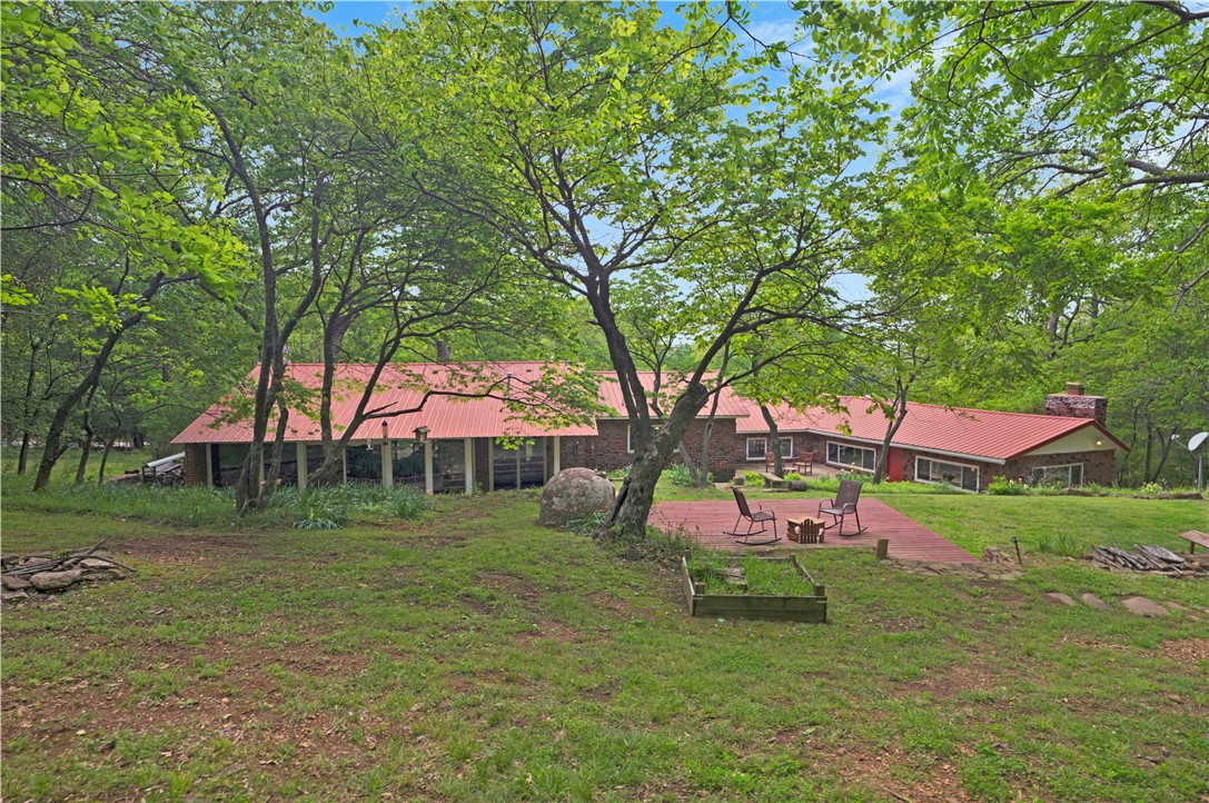 See this totally renovated this Mt Sequoyah home. The property consists of 3 parcels with a separate guest cottage as well as a buildable lot allowing you peaceful privacy with room to expand.  3 Baths & 4 Bedrooms including a primary bedroom with a wood burning fireplace, spacious bath, & double glass doors leading to one of several outdoor patios.  A second bedroom with an ensuite bath is another primary  bedroom option.. The living & dining areas occupy  a huge space with floor to ceiling windows allowing beautiful views of the  1.77  acre naturally wooded lot.  Your kitchen  opens to a spacious patio & is fitted with everything on the cook's wish list.  The  cottage offers an open living & kitchen, & an inviting bedroom, & a bath. Two porches enhance the cottage for outdoor living. Live here & enjoy life on Mt Sequoyah. Located just minutes from the Mt Sequoyah overlook, the U of A , Fayetteville's square & Dickson St.