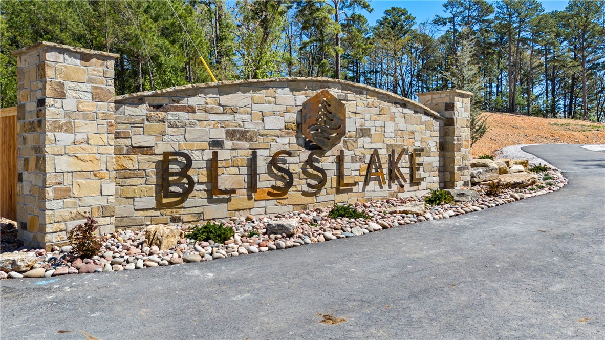 Discover the perfect canvas for your custom Beaver Lake area retreat at Blisslake, a new fully paved subdivision featuring 9 premier estate-sized lots with dedicated community recreation area and lakefront access for all lot owners. This 4.52-acre lot offers the ideal blend of privacy, natural beauty, & proximity to some of Northwest Arkansas' most sought-after amenities. Ideally located at the Northern end of Beaver Lake near Hobbs State Park & Rocky Branch Marina, the property is surrounded by endless opportunities for hiking, biking, boating, & outdoor recreation as well as just 20 minutes from downtown Rogers! The sloping terrain & serene wooded setting provide an exceptional backdrop for a luxury home designed to complement the Ozark landscape. Underground electric & water are available at the street, allowing for a visually clean, unobstructed setting while streamlining the building process. Build your dream home & experience the best of the Natural State!