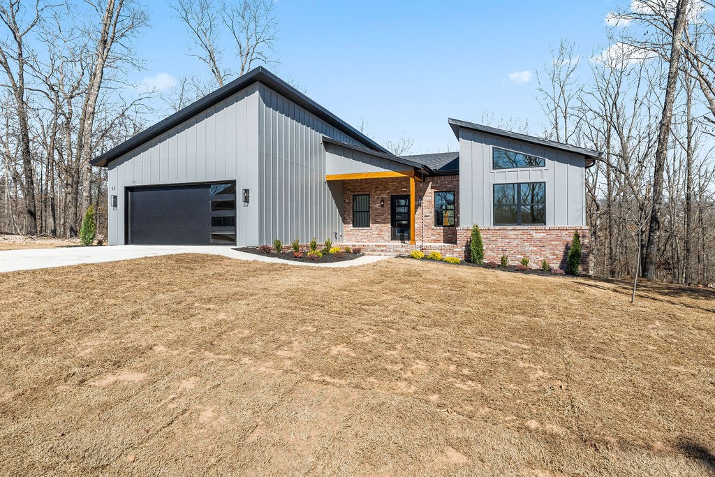 *Agent Owned* A modern new construction delight just a half mile bike ride to the Back 40 Trails! Built by Christopher Hayes Homes and thoughtfully designed inside and out. 1,858 sq ft, 3 bed, 2 full bath & 2-car attached garage—all on one level. With 10 foot ceilings, desirable split floor plan complimented with an open main living room/kitchen area perfectly customized with a waterfall island, floating shelves, built-ins & included 75 inch flatscreen TV. The leathered granite countertops, LED lighting, & modern finishes blend style & function. Exceptional primary bath featuring dual showerheads, primary closet with storage shelves all the way to the top, you are sure to feel the quality craftsmanship throughout that add comfort and convenience. Exterior showcases classic brick, board & batten, cedar accent, and a covered, oversized deck. Home sits on a quiet dead end street waiting to be called home.