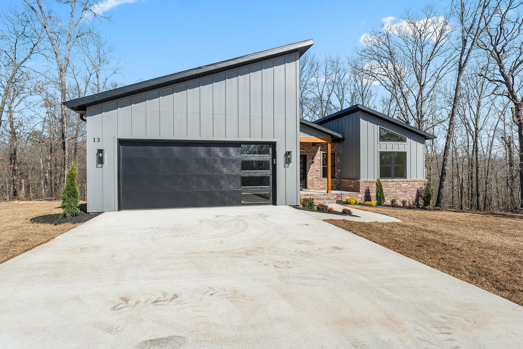 *Agent Owned* A modern new construction delight just a half mile bike ride to the Back 40 Trails! Built by Christopher Hayes Homes and thoughtfully designed inside and out. 1,858 sq ft, 3 bed, 2 full bath & 2-car attached garage—all on one level. With 10 foot ceilings, desirable split floor plan complimented with an open main living room/kitchen area perfectly customized with a waterfall island, floating shelves, built-ins & included 75 inch flatscreen TV. The leathered granite countertops, LED lighting, & modern finishes blend style & function. Exceptional primary bath featuring dual showerheads, primary closet with storage shelves all the way to the top, you are sure to feel the quality craftsmanship throughout that add comfort and convenience. Exterior showcases classic brick, board & batten, cedar accent, and a covered, oversized deck. Home sits on a quiet dead end street waiting to be called home.