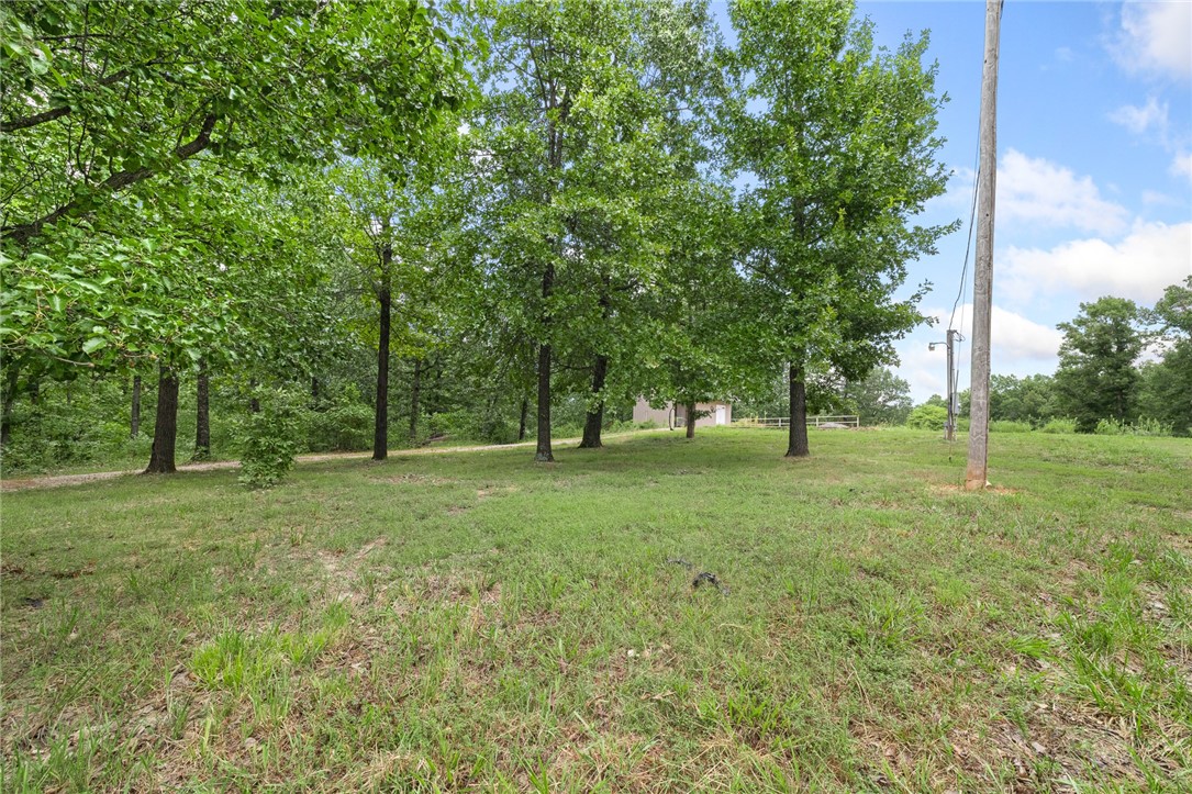 Escape to your own private retreat on 40+ secluded, wooded acres tucked away at the end of a quiet road—an ideal setting to bring your dream home to life. A prepared building site stretches along the driveway, complete with plans for a stunning 5,000 sq ft residence. Utilities are already in place, including rural water, electricity with a 50-amp outlet, and a septic system designed for up to six bedrooms. The property also features a buried, full 500-gallon propane tank, an excavated pad for a 40x60 shop, and scenic trails winding through the land. Enjoy abundant wildlife, a hunting stand, a secure storage shed on a concrete slab, and even a level area ready for a chicken coop. Whether you're seeking tranquility, adventure, or both—this property offers limitless potential.
