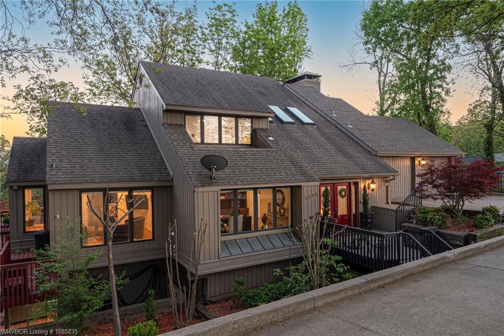 This stunning home on Cliff Drive in Fort Smith, AR, offers breathtaking views overlooking the lush landscape near Hardscrabble Country Club. Elevated for maximum scenery, the home is thoughtfully designed to take full advantage of its surroundings — stairs both in and out that come with the territory when you're perched directly across from one of the most scenic spots in town. Built with multi-generational living in mind, the spacious layout features separate living areas that offer both privacy and connection. Large windows capture the views from nearly every room, while high-end finishes and inviting outdoor spaces make this home ideal for entertaining or relaxing. Located in one of Fort Smith’s most desirable neighborhoods, this home blends comfort, elegance, and convenience — with the option to be sold fully furnished at a higher price point.
