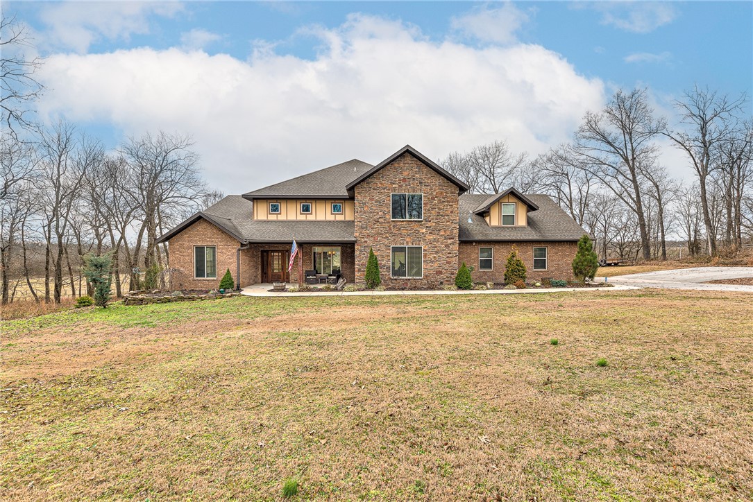 An elusive, beautifully crafted custom home offering 4 bed 4 baths on 9 scenic acres within the Bentonville School District. Enjoy resort-style outdoor living with an in-ground pool, hot tub, and fire pit overlooking a stunning valley—ideal for entertaining or peaceful sunset views. The land is perfectly suited for horses or a variety of outdoor activities. The gourmet kitchen boasts commercial-grade appliances. Huge Master Suite. The pantry doubles as a storm shelter. A thoughtfully designed mother-in-law suite includes a roll-in shower.