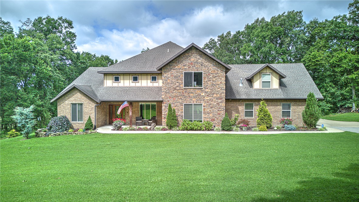 An elusive, beautifully crafted custom home offering 4 bed 4 baths on 9 scenic acres within the Bentonville School District. Enjoy resort-style outdoor living with an in-ground pool, hot tub, and fire pit overlooking a stunning valley—ideal for entertaining or peaceful sunset views. The land is perfectly suited for horses or a variety of outdoor activities. The gourmet kitchen boasts commercial-grade appliances. Huge Master Suite. The pantry doubles as a storm shelter. A thoughtfully designed mother-in-law suite includes a roll-in shower.