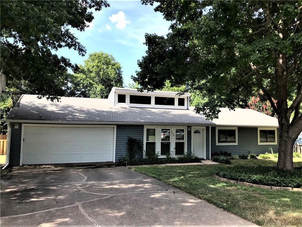 Wonderful family home near schools, shopping, the university and I-49. A very convenient location. Established neighborhood. Open living with elevated ceiling with clerestory windows for passive south lighting. Gas log fireplace and built-ins. Formal dining room, eat-in kitchen, ceiling fans, new granite counters in kitchen, updated in kitchen and bathrooms, wood laminate in formal dining room, living room & hallway. All windows replaced. Landscaped yard front & back. Large private back deck 14 x 30. Storage shed. HVAC 2015. New kitchen appliances.