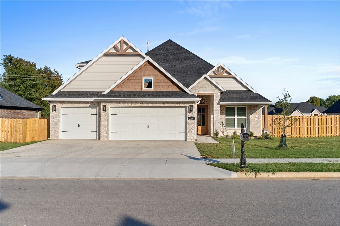 The Jennifer Plan, mid build process.  LOT 145. This south facing home has 2,696 sq ft and is set for completion on approximately 8-1-26.  *Photos shown are of a finished home in the same plan.*  Upon entering the foyer Step into a bright and inviting living room with vaulted ceilings and wood beams. The kitchen includes a walk-in pantry and a cozy breakfast nook. The primary suite is thoughtfully designed to offer privacy, featuring direct access from the master closet to the utility room. Also located on the main floor is a bedroom ideal for guests or a home office. Upstairs, you'll find two additional bedrooms with a shared full bathroom. 3-car garage and covered front and back patio and an outdoor wall gas fireplace. Walk to nearby schools and just minutes to Downtown Bentonville. Community pool and clubhouse located right around the corner. Introductory pricing for a  very limited time. Will go up soon, contract today.