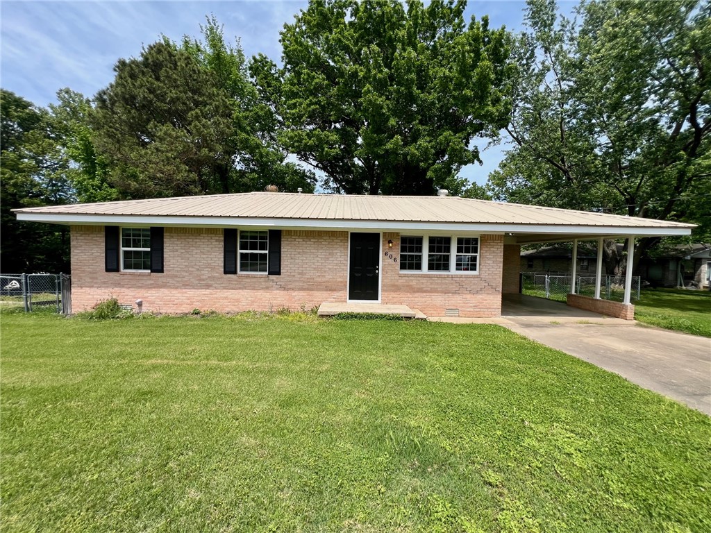 Welcome home! A well-maintained 3-bedroom, 2-bath single-family rental offering comfortable living in a quiet residential setting. This home features a functional layout, neat and clean finishes, great classic floors, essential appliances, and washer/dryer hookups for everyday convenience. Enjoy a fully fenced in yard and a carport with additional storage space. Located near local schools, parks, and downtown Gravette, the home combines small-town charm with practicality. Just minutes from I-49, which provides an easy commute to Bentonville, Rogers, and surrounding Northwest Arkansas, making it a great option for those seeking affordability with strong regional access. Pets negotiable with pet policy of $250 non-refundable + $50/month.