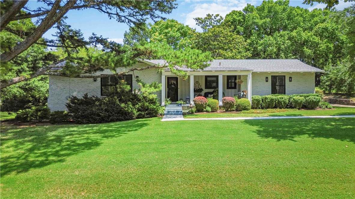 Enjoy the nostalgia of one of Fayetteville's favorite neighborhoods! Completely renovated down to the studs in 2018- new electrical, plumbing, roof, hot water tank, flooring, doors, and fixtures- with new windows and plantation shutters added since. Cook's kitchen features granite countertops, island with veggie sink, stainless appliances, and tons of serving area, all open to a hearth room with wood-burning fireplace. Hardwood floors throughout plus a den and living room. Bathrooms offer new cabinetry, quartz counters, and marble showers. All on .71 acre with gorgeous rock walls, circle drive, oversized garage, and potters shed. Out back, gather around the fire table on the new decking-the perfect spot to end the day. Character, quality, and location-a rare combination.