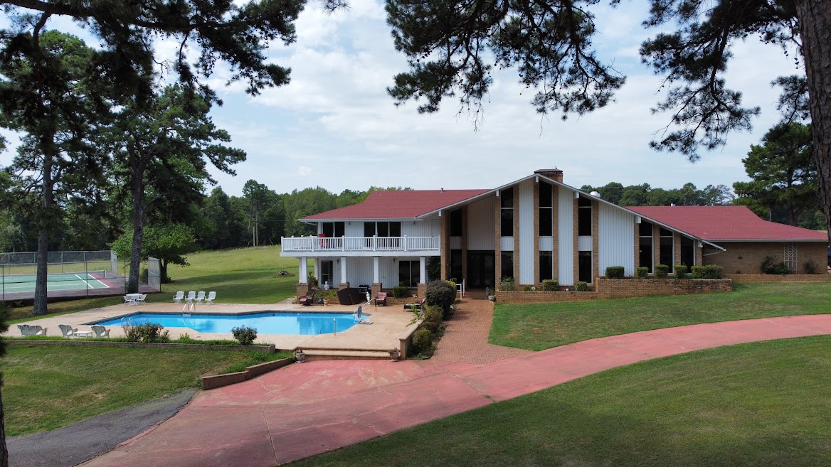 One of a kind. There's so much to this property it is hard to list it all. Including 2 homes. The main house is an original designed by well known architect is 5,258 sq ft heated and cooled. This one includes 5 bedrooms, 6 bathrooms, 2 living areas ,not just one but 2 floor to ceiling brick fireplaces. The master has its own balcony, and the master bath has 2 separate identical sinks and counter tops and master tub big enough to swim in, a wet bar, an indoor sauna, an inground 9 ft swimming pool, 2 upper deck (to see the amazing view of the mountains) 4 car garage, tennis court, a barn and much more.

The guest house is a cute cottage that has 3 bedroom 1 bathroom. 

The property has 2 ponds and thousands of yards of white fencing. It is not far from the national forest, the Arkansas River, and local lakes. There's bike trails, ATV trails, hiking trails everywhere in this part of Arkansas