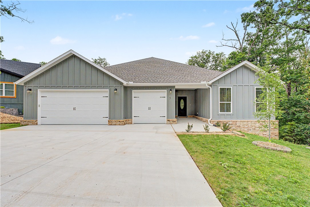 Beautiful new construction 5BR/3BA home in Bella Vista featuring modern finishes, an open-concept layout, and a peaceful wooded setting. The spacious living room offers 11 ft ceilings, abundant natural light, and a gas log fireplace that creates a warm focal point. The kitchen is designed for entertaining with quartz countertops, custom cabinetry, stainless steel appliances, large center island, and stylish backsplash details. The private primary suite includes a spa-inspired bath with double vanities, soaking tub, walk-in shower, and generous walk-in closet. Durable wood-look flooring flows through the main living areas with comfortable carpet in the bedrooms. Step outside to enjoy the covered back deck overlooking the large backyard and surrounding trees. Conveniently located near Bella Vista's golf courses, lakes, Bike trails, and amenities with easy access to Bentonville. This house is on city sewer system. There is also a 250 square feet storage space downstairs. The garage has a 240V outlet ready for your EV.