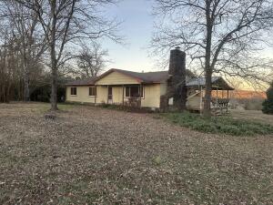 Road frontage on two sides of the land. Beautiful farm stead that you will not want to miss. The home features 3 bed/2 full bath with a nice wrap around porch to sit and enjoy your mountain view. House needs a little update but nothing too major. It has city water but also a well for watering your animals and garden. 3 nice ponds stocked with catfish and blue gill bass. One of the ponds is fed by a branch of creek . Two barns and a well house/shed. Some minerals may transfer. There are pear, apple, peach and mulberry trees to enjoy fresh fruit. The property has multiple pastures that are fenced and crossed fenced. One of the ponds has a pump that runs to your perfect garden spot. AT THIS PRICE THE PAYING VERIZON CELL TOWER LEASE IS INCLUDED. YOU CAN BUY JUST THE HOUSE AND ACREAGE FOR $389,900.
