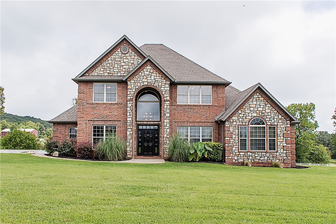 Breathtaking 2.5 acre Estate. Spacious flr plan has beautiful red oak hardwood flrs, cathedral ceilings, built-ins & recessed lighting. KIT features granite countertops, ss app, eat-in area, pantry & FDR. Elegance continues to the Master Suite where you'll find MBA w/his & her vanities, whirlpool tub & tiled walk-in shower. Upstairs there are 3 more BR's, BA w/ double vanities, work area & a Razorback fans dream rm to watch the game. Covered back deck w/sitting area overlooks stunning & relaxing views.