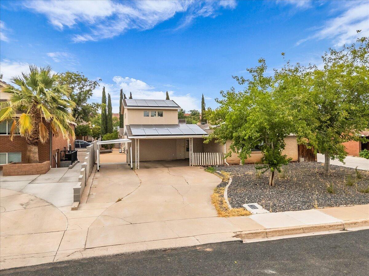 Conveniently located in the heart of downtown St. George, this inviting home offers easy access to Utah Tech University, St. George Regional Hospital, Vernon Worthen Park, schools, shopping, and dining. The bright, open floor plan is filled with natural light and features a spacious living and dining area that's ideal for both everyday living and entertaining. French doors lead to a covered side patio, creating the perfect space to relax or host guests year-round. The updated kitchen showcases granite countertops and a generous walk-in pantry. Throughout the home you'll find built-in storage, ceiling fans, and two cozy fireplaces that add warmth and character. The spacious primary suite features two walk-in closets, while the unfinished upstairs bonus room provides endless possibilities for additional living space, a home office, or a hobby room. Move in ready!!