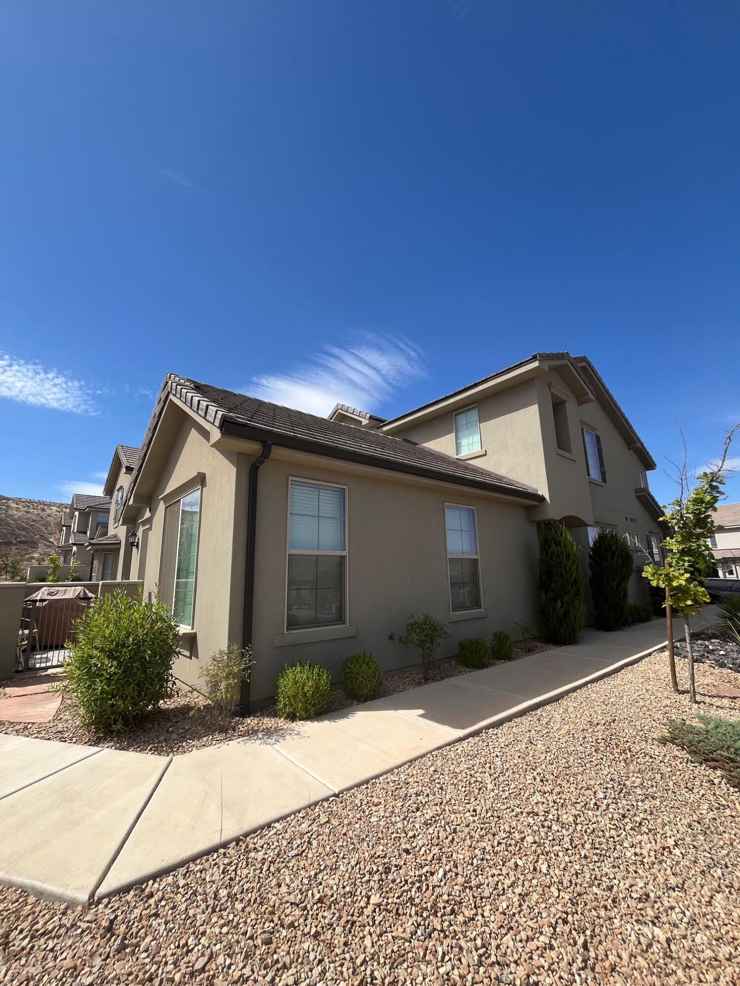 FULLY FURNISHED move-in-ready end-unit townhome with main floor master. This home has been well cared for and is in pristine condition. Home has a coveted 3.5 baths & all bedrooms are ensuite with their own FULL bath! Vaulted ceilings in great room. Elegant kitchen has both a warm feel & modern design. Family room gazes out onto a LARGE section of beautifully landscaped common area, which gives the residence more privacy than neighboring homes! Unit has excellent orientation, helping it stay cool in the summers! HOA includes all exterior yardwork, access to community pool, hot tub, & lounge area. Nearby Hidden Valley Park is one of the top parks in St George w/ a splashpad, massive playground, tennis, volleyball,. OWNER AGENT