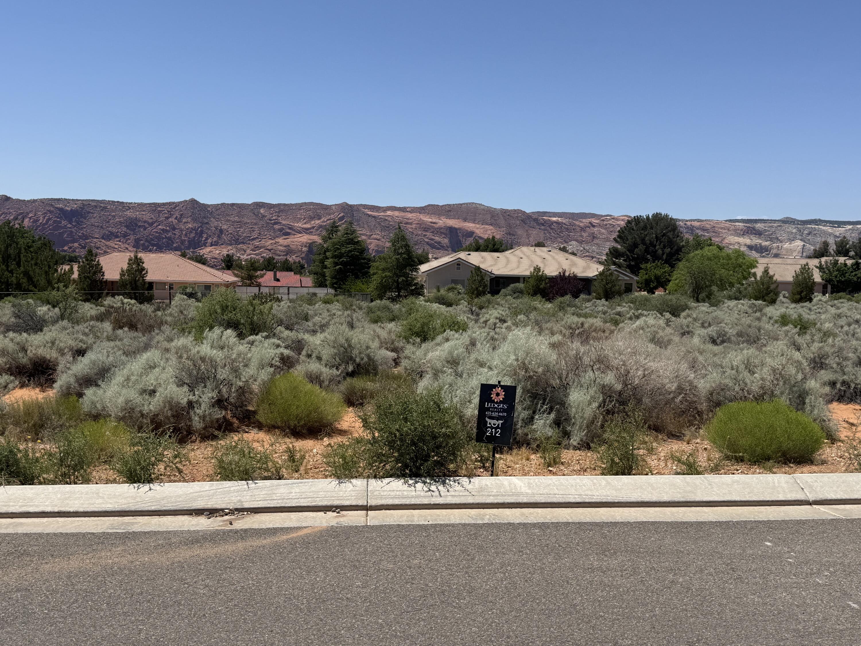 This property offers breathtaking views of the vibrant Snow Canyon State park red rock, providing a picturesque backdrop for your dream home. This 0.70 acre lot is able to use any builder, with low HOA fees.