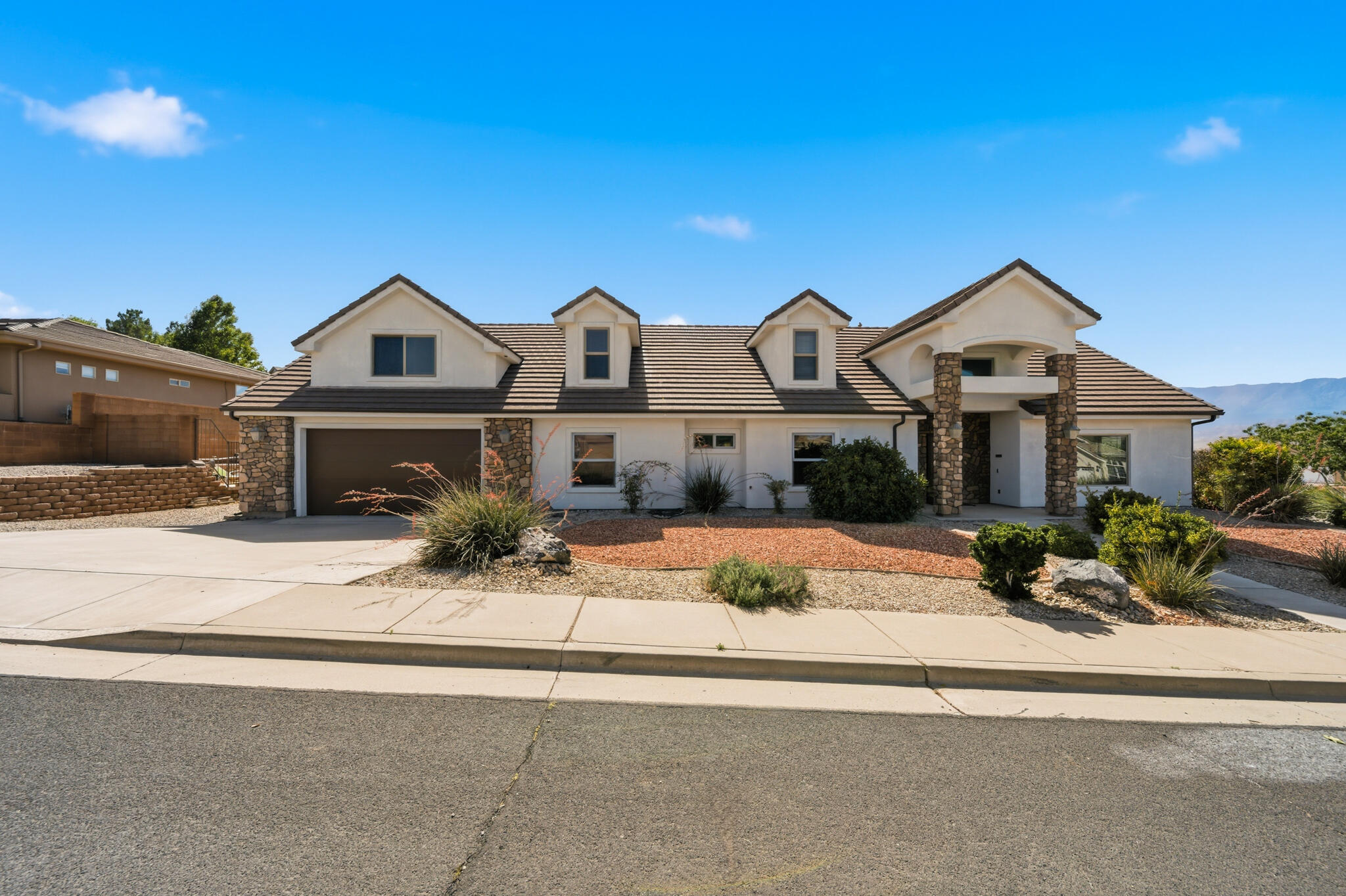 Perched in the desirable Painted Hills community, this beautifully maintained home offers the perfect blend of comfort, space, and Southern Utah adventure. With breathtaking views from nearly every window and a private pool creating your own backyard retreat, this is the type of home that makes everyday living feel like a vacation.

Inside, you'll find a thoughtfully designed floor plan with generous living spaces, soaring vaulted ceilings, and large windows that flood the home with natural light while showcasing the surrounding red rock scenery. The updated kitchen features custom cabinetry, abundant storage, and plenty of space for gathering with family and friends. The inviting living room centers around a cozy fireplace, creating the perfect place to relax after a day exploring Southern Utah.

The spacious layout continues upstairs with additional guest bedrooms and a versatile family room complete with a convenient kitchenette--ideal for entertaining, multi-generational living, long-term guests, or creating the ultimate game and movie room. Fresh interior paint adds to the home's move-in ready appeal.

Step outside and discover your own private oasis. The 13' x 13' pool, pergola-covered patio, and expansive outdoor living space create the perfect setting for summer gatherings, evening sunsets, and year-round enjoyment of Southern Utah's incredible climate.

Beyond the property itself, the location is exceptional. Residents enjoy quick access to outdoor recreation including Sand Hollow State Park, Quail Creek State Park, and the popular Hurricane Hill Trailhead, offering endless opportunities for boating, paddleboarding, hiking, biking, off-roading, and exploring the region's famous red rock landscapes. Nearby attractions such as Red Reef Trail, Grandpa's Pond Park, and Zion National Park provide adventure just minutes from home.