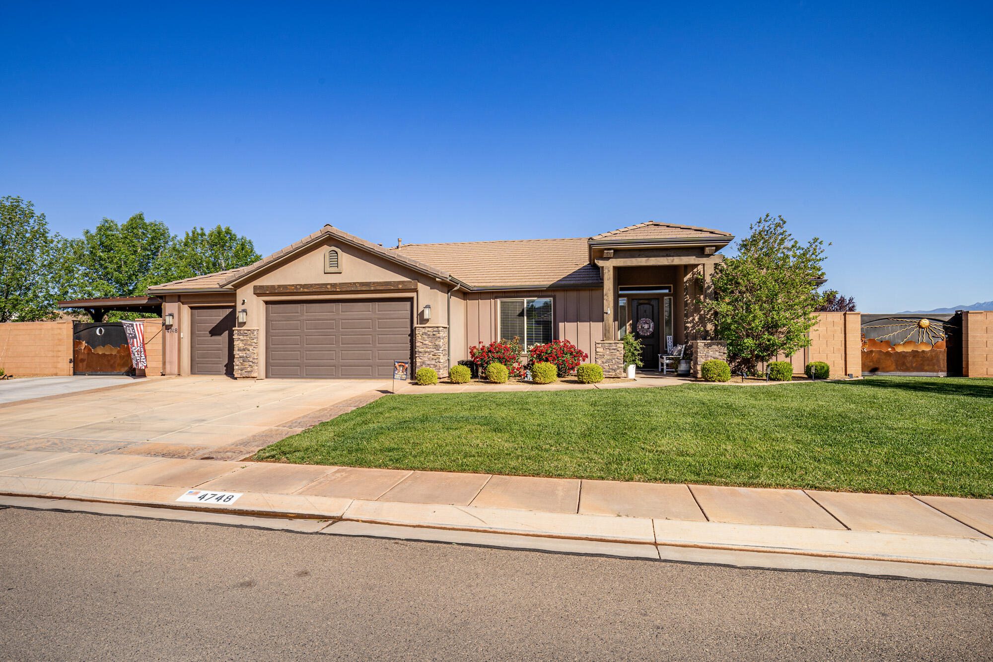 This beautifully maintained Craftsman-style home sits on a spacious corner lot in the desirable Homesteads at Stucki Farms and offers the perfect blend of comfort, functionality, and outdoor living.

Inside, you'll find 4 bedrooms and 2 bathrooms, with a flexible fourth bedroom that can easily serve as a home office or den. The kitchen is thoughtfully designed with double wall ovens (including a convection oven), a gas cooktop, and convenient cabinet slide-outs that make everyday living easier. The home has been meticulously cared for, with attention to detail throughout.

Step outside and enjoy the benefits of a large 1/3-acre lot with no neighbors on either side, giving you added privacy and space. The backyard is beautifully landscaped and includes a hot tub--perfect for relaxing evenings. Permanent holiday lighting adds year-round convenience and charm.

Car enthusiasts and hobbyists will appreciate the temperature-controlled 3-car garage, along with additional covered and gated RV parking. There's also a temperature-controlled storage shed and custom gates for added functionality and security. A backup generator provides peace of mind.

Living in Stucki Farms means access to fantastic community amenities, including pools and a clubhouse, all just minutes from outdoor recreation at Warner Valley and Sand Hollow Reservoir.

Some furnishings may be negotiable, making this an even more attractive opportunity.