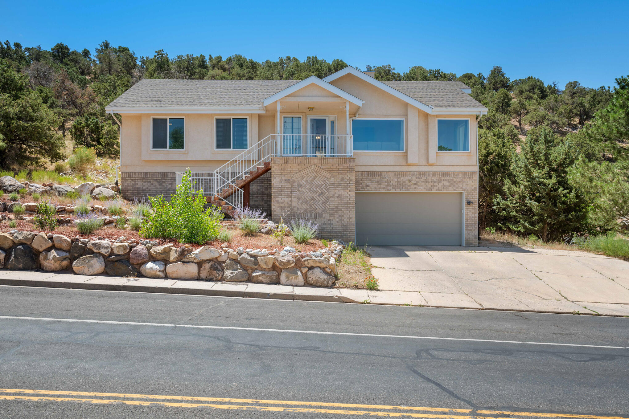Discover serenity and space in this picturesque 4 bedroom 2 bathroom home boasting panoramic views of the valley. Nestled on a large lot, this residence offers both comfort and convenience with recent upgrades including new windows and a roof installed in 2019. Step inside to find a top-level open floor plan that invites natural light to every corner. For added versatility, the lower level includes a 2 car garage and a bonus room, perfect for a home office, gym, or 4th Bedroom. Outside, the property is complemented by a tranquil setting, backed up to a wooded hill ensuring privacy and a connection to nature.