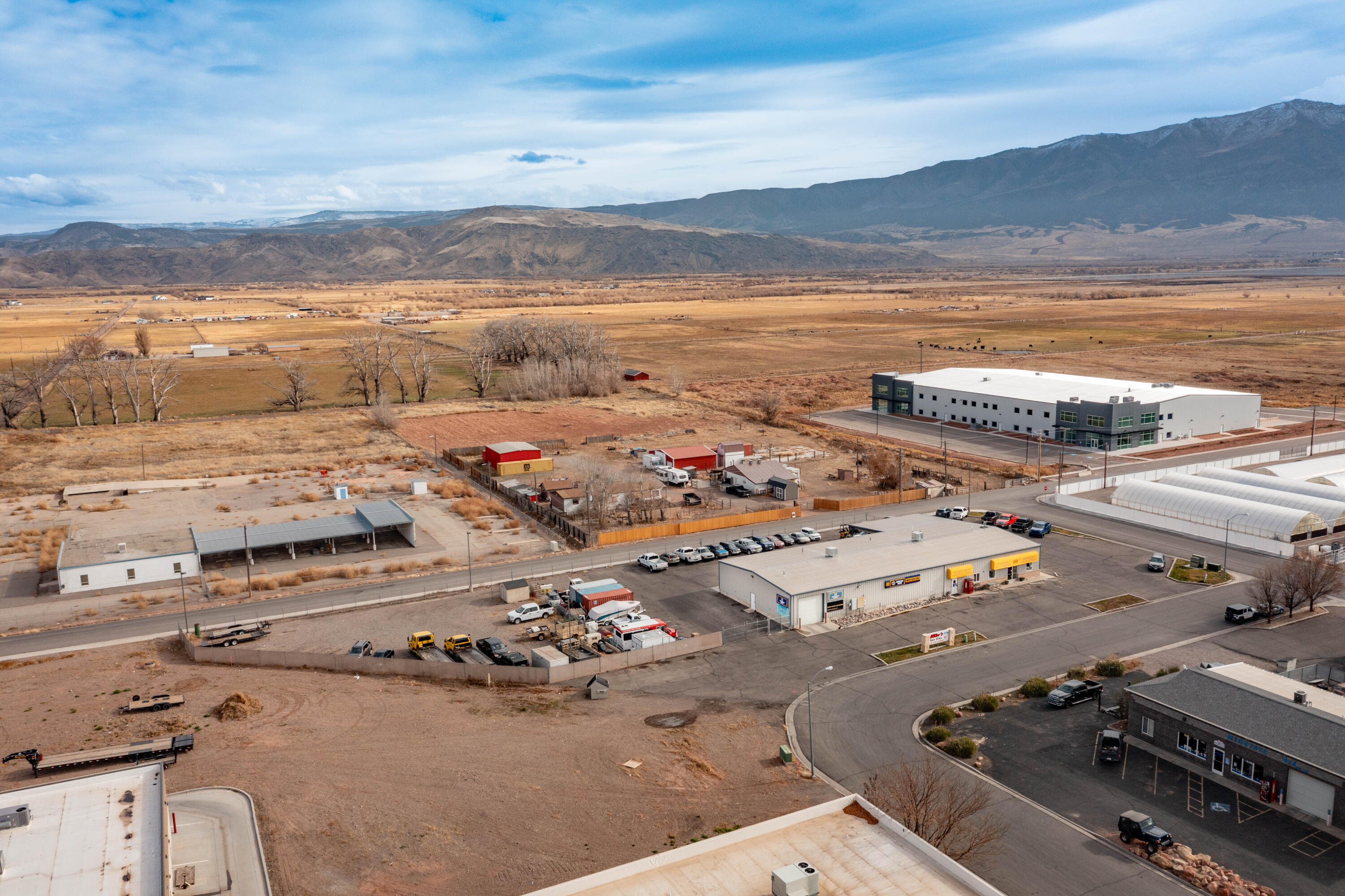 Prime commercial building with auto shop and three income-producing tenants. It sits just one block off South Main near Walmart and I-70. The property includes five service bays, upgraded AC (2025), fully asphalted parking and storage areas, and an oil-water separator-significant cost savings compared to new construction. The site benefits from rare grandfathered industrial zoning, eliminating today's impact fees and drainage requirements typically imposed at other sites. Three spaces currently leased to an auto detailer, salon, and bookstore provide approx. $1,950/month in additional income. When combined with the auto shop's operating income, the projected performance indicates an estimated CAP rate of 10.25%, depending on buyer structure and if the business is acquired alongside the property (buyer to verify all financials independently). Mike's Auto Clinic, a respected 35-year business, along with its trained staff, customer base, and approximately $200K in equipment, may be purchased separately. Financials are available with a signed NDA. Seller is willing to assist with transition making this a strong turnkey opportunity with significant growth potential including towing, heavy-equipment/AG repair, fleet services, body/paint, or equipment rental (buyer to verify). List price reflects real estate only; business and equipment are optional.