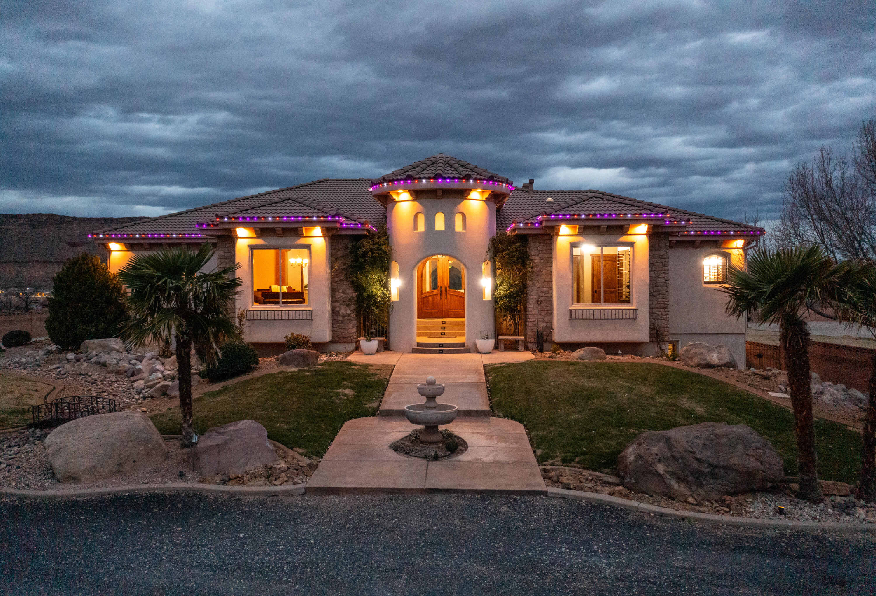 Your very own PRIVATE Virgin River Equestrian Estate on 2 ACRES with all your DREAM FEATURES, stunning VIEWS and the ultimate OUTDOOR LIVING. This fine LUXURY CRAFTED home is finished with engineered hardwood and travertine flooring throughout. The Main WALK-OUT BASEMENT Home is 5,800 sq. ft. w/ 6 bedrooms, 4 full bathrooms, & 2 half bathrooms & 2 large gathering areas. The Primary Owner Suite is on the MAIN LEVEL and the 2nd OWNER SUITE is in the basement. The spacious kitchen has 2 COPPER SINKS, Built-in APPLIANCES and GIANT HIDDEN PANTRY. The basement has a FULL 2nd KITCHEN, private THEATER with all the equipment, a 2nd LAUNDRY Room & several storage rooms. The detached GUEST QUARTERS / ADU is 600+ Sq. Ft. and comes with 1 Bedroom, 1 Bathroom, laundry area and full kitchen. The RV GARAGE is insulated with a mini-split system and includes a car lift.  Total garage space is 2305 Sq. Ft., so tons of parking for cars, trailers and toys.  This estate is ideal for hobby farm and very animal friendly w/  horse corrals, tack shed, and pastor w/ access to the Virgin River.  The BACKYARD OASIS includes a pristine SWIMMING POOL, hot tub, playground, full bathroom and BUILT-IN BBQ. 3,000 sq. ft. of COVERED PATIO space for beautiful views of Pinevalley Mountain, Virgin River and the Red Rock Candy Cliffs.