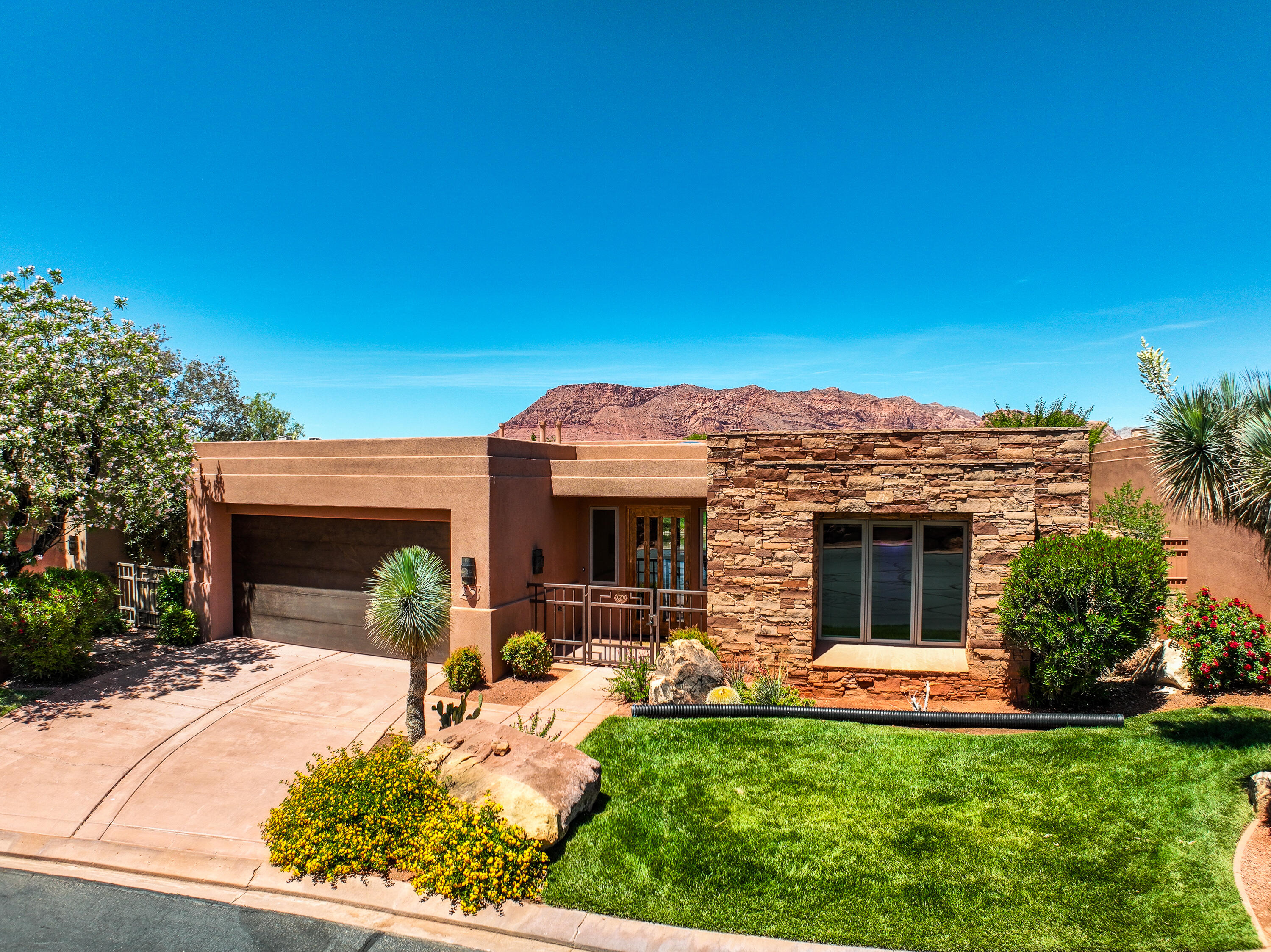 Experience elevated desert living in the prestigious Kachina Springs at Entrada. This stunning view home showcases breathtaking panoramas of Snow Canyon, ideal for relaxing or entertaining year-round. Inside, the home features high-end finishes including Wolf appliances, granite countertops, slate and hardwood flooring, skylights and much more. Thoughtfully designed with abundant built-in storage throughout, every space is both functional and refined. The spacious primary suite offers a private retreat with a fireplace, cozy sitting area, and a generous walk-in closet. Located just steps from one of Southern Utah's most iconic golf courses, this home delivers the perfect combination of luxury, views, and lifestyle. Additional HOA dues of $234/month for Associate Membership is required, call agent for details.