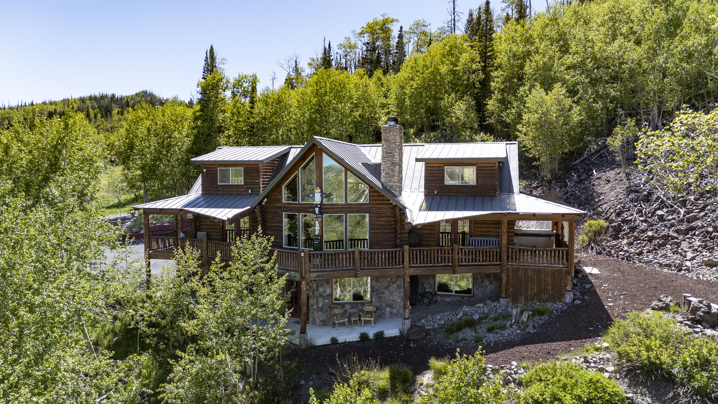 Experience the ultimate après-ski retreat in Brian Head with this exceptional ski-in/ski-out luxury true log cabin offering some of the best views on the mountain. Situated on two lots totaling 0.86 acres, this fully furnished 4,296 sqft home showcases panoramic views of six ski lifts and breathtaking mountain scenery. Lovingly maintained by a single family since construction and never rented. 

Thoughtfully designed with 4 bedrooms, 4.5 bathrooms, including 3 en-suite bedrooms, plus a dedicated office, the home provides ample space for family and friends. Warm and efficient, with radiant in-floor heat throughout the home and attached 1,200 sqft garage, complemented by two high-efficiency airtight wood-burning stoves and a cozy gas fireplace in the primary suite. Additional highlights include a game room with pool and air hockey tables, theater area, Sundance Spa, fire pit with seating, custom-built log beds, and abundant storage throughout.

Outdoor features include a remote-controlled private gated entrance, large storage shed, enclosed wood storage, driveway lighting, hardwired security cameras, whole-house surge protector and a 20,000-watt natural gas whole-house generator with an automatic transfer switch, providing added convenience and peace of mind.

Snowmobiles and Bobcat with bucket and snowblower attachment can be purchased separately.