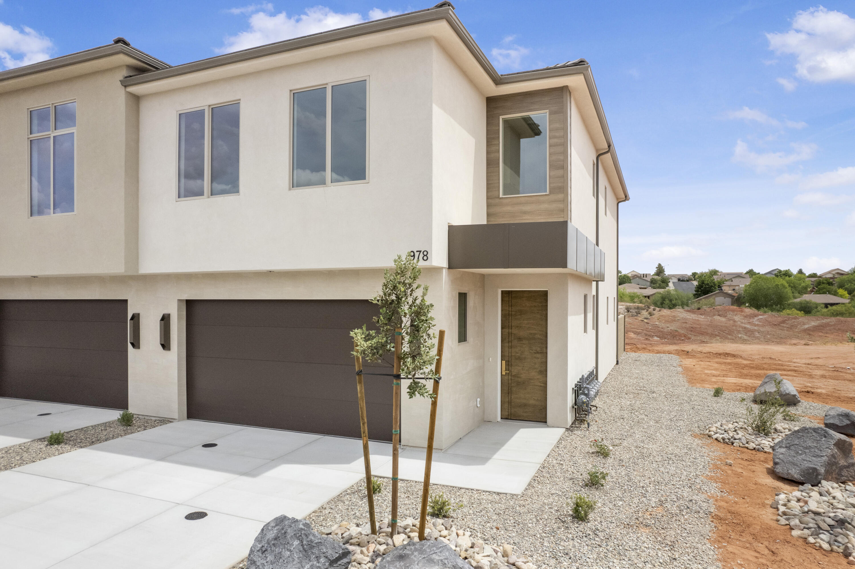 Experience elevated living in this brand-new luxury end-unit townhome designed with exceptional quality, style, and comfort in mind. From the moment you walk in, you'll notice the soaring tall ceilings, oversized windows filled with natural light, and thoughtfully designed open living spaces that create a bright and inviting atmosphere.  This stunning home features high-end appliances, designer finishes, beautiful lighting, and impressive 8-foot doors throughout, delivering the feel and sophistication of a custom luxury home. The exterior architecture is equally remarkable with elegant Italian tile accents, designer metal details, and a striking high-end front door that creates unforgettable curb appeal.  Enjoy your own private backyard and patio area -- perfect for relaxing, entertaining, or simply enjoying the low-maintenance lifestyle this community offers. The amenities are second to none, featuring a resort-style pool, pickleball courts, walking trails, parks, and outdoor exercise stations. More than just a home, this is a lifestyle centered around luxury, convenience, and carefree living where the landscaping and exterior maintenance are handled for you, allowing you to spend more time enjoying life.  These photos are of a 3 bedroom unit in this same building and may or may not be the actully unit addressed above.