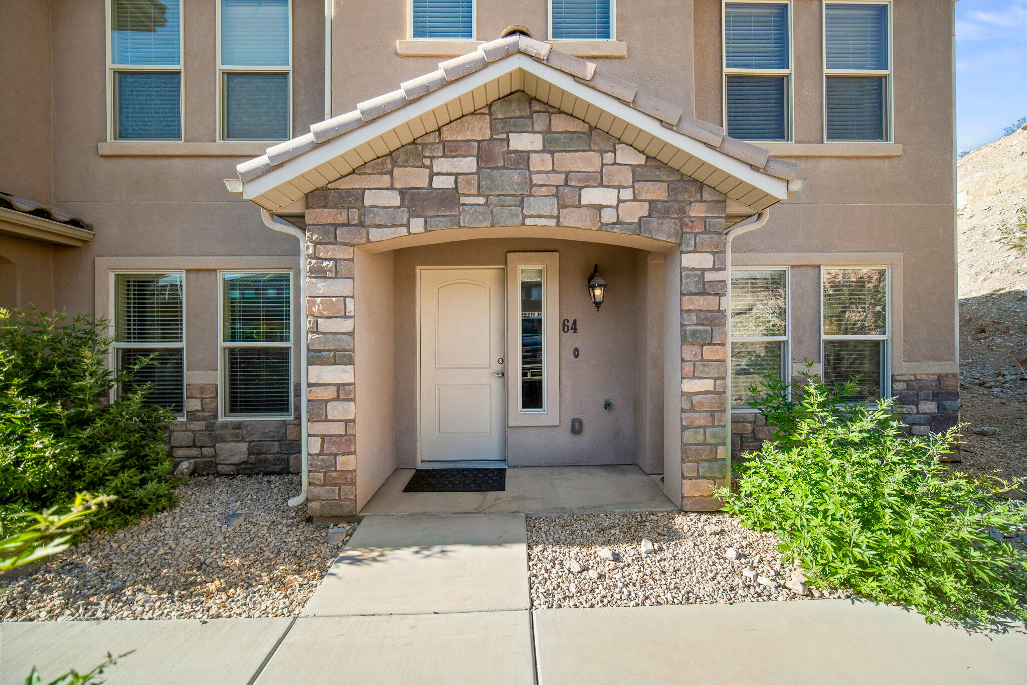 Perfectly located end unit! Extra windows, newer flooring, laundry room by bedrooms, nice, north facing patio area with parking at your front door. Great amenities! Pool, clubhouse, gym, playground and space to walk the dog. Buyer to verify all info.