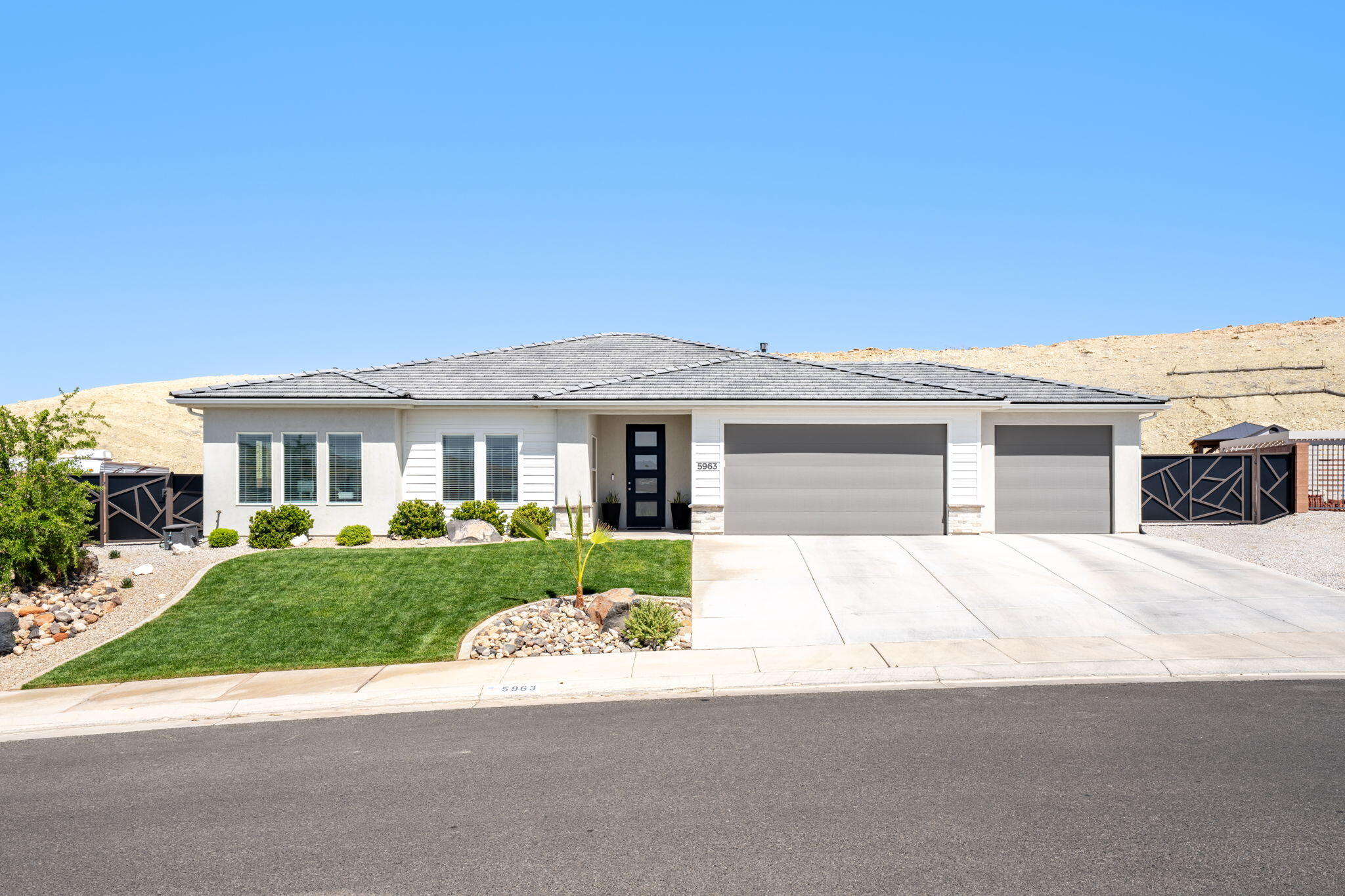 Enjoy the perfect blend of modern comfort, privacy, and adventure in this beautifully upgraded Southern Utah home surrounded by Pine Valley views and endless outdoor recreation. Thoughtfully designed with bright, inviting finishes throughout, the interior features oversized guest bedrooms, and a spacious primary suite with an enormous walk-in closet and gorgeous tile shower. The stunning kitchen is highlighted by quartz countertops throughout, light white and brown cabinetry, and beautifully upgraded higher-end finishes that create a clean, modern, and luxurious feel. The beautifully finished laundry room with matching quartz surfaces adds both style and functionality. Car enthusiasts and outdoor adventurers will love the oversized 3-car garage, super deep side RV and trailer parking that can easily accommodate multiple trailers and toys, plus a hardwired Level 2 electric car charger. Step outside to a peaceful backyard retreat that backs to a hillside, creating exceptional shade, privacy, and stunning Pine Valley views with no highway noise to interrupt the tranquility, all while being walking distance to the brand-new Southern Hills Park, the upcoming tech high school, and next door to world-class mountain biking, hiking, and off-road trails. Buyer to verify all information, deemed reliable, however buyer to verify all info including utilities, rental restrictions, and HOA information if applicable.