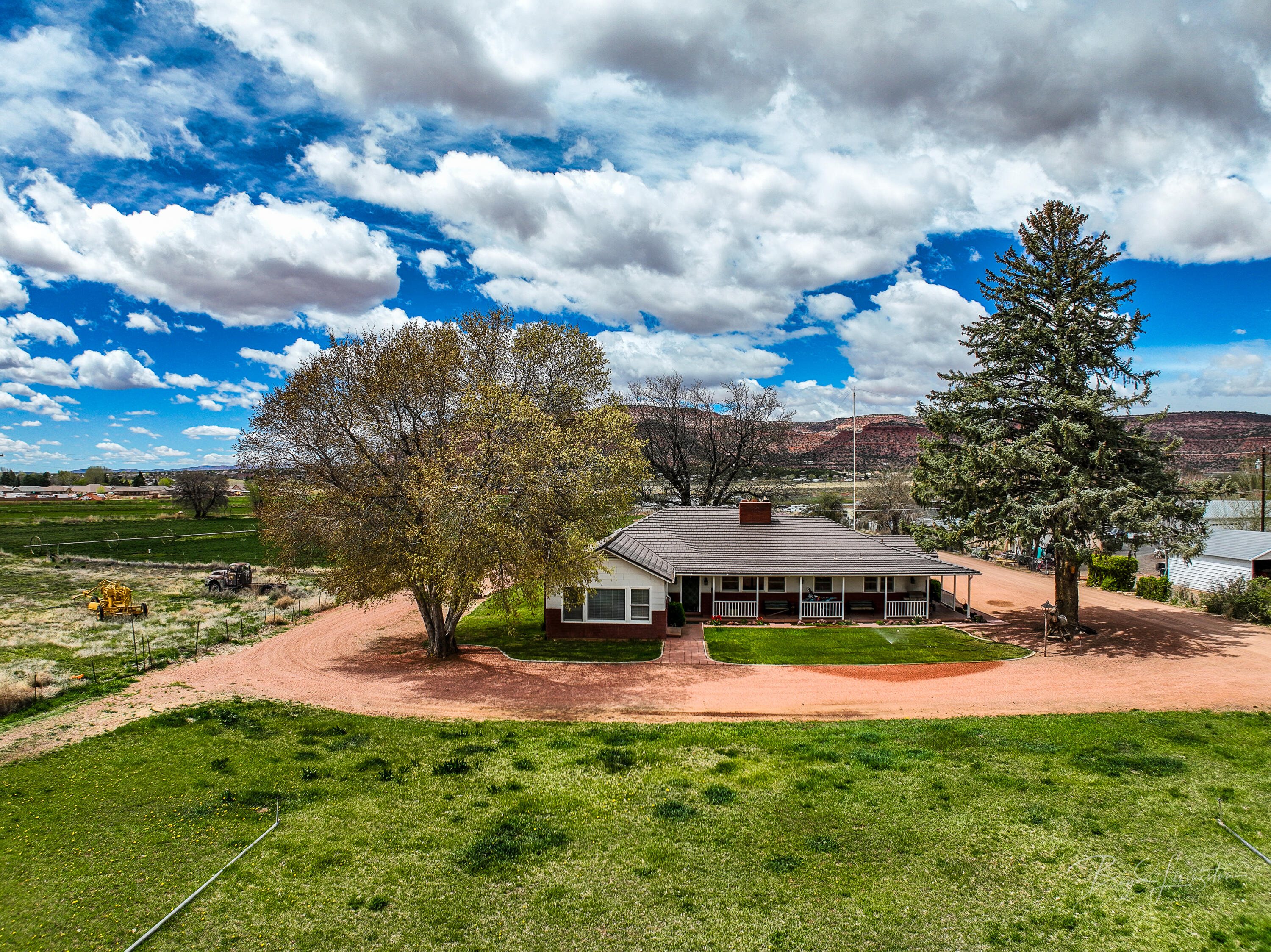 Seller Financing! Welcome to your slice of paradise nestled in the heart of Kanab, surrounded by stunning red rock landscapes. This 10.29-acre gentleman's ranch offers a unique blend of versatility with multiple zoning options, including commercial, multi-family, and residential. The property features a spacious 2,886 square foot vintage home boasting timeless charm, with 4 bedrooms and 3 bathrooms. Outside, a sprawling pasture, corrals, and irrigation system offer ample space for livestock and agricultural.

A substantial outbuilding at the rear of the property a perfect space for working on large farm equipment or storing equipment. Whether you're seeking a serene residential retreat or an entrepreneurial venture, this rare find offers endless. Listing agent is relative to seller