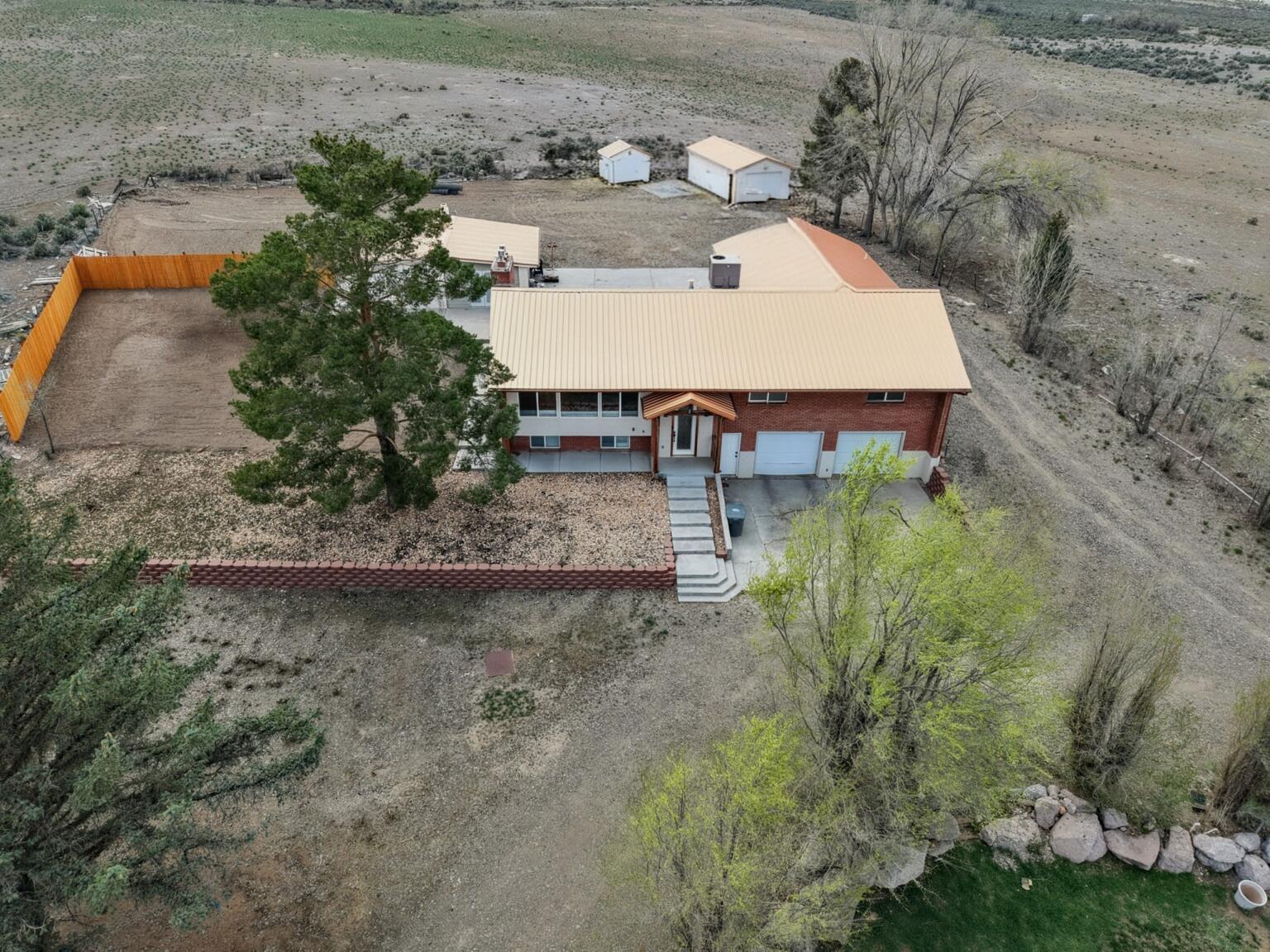 Just under 1 acre with beautiful 2784 square foot home in Panguitch, UT. Landscaped with evergreen and deciduous trees, lots of parking, storage, and out buildings. Wood floors throughout main level, tile in basement. Oversize garage, private well, new appliances. Call for a private tour.