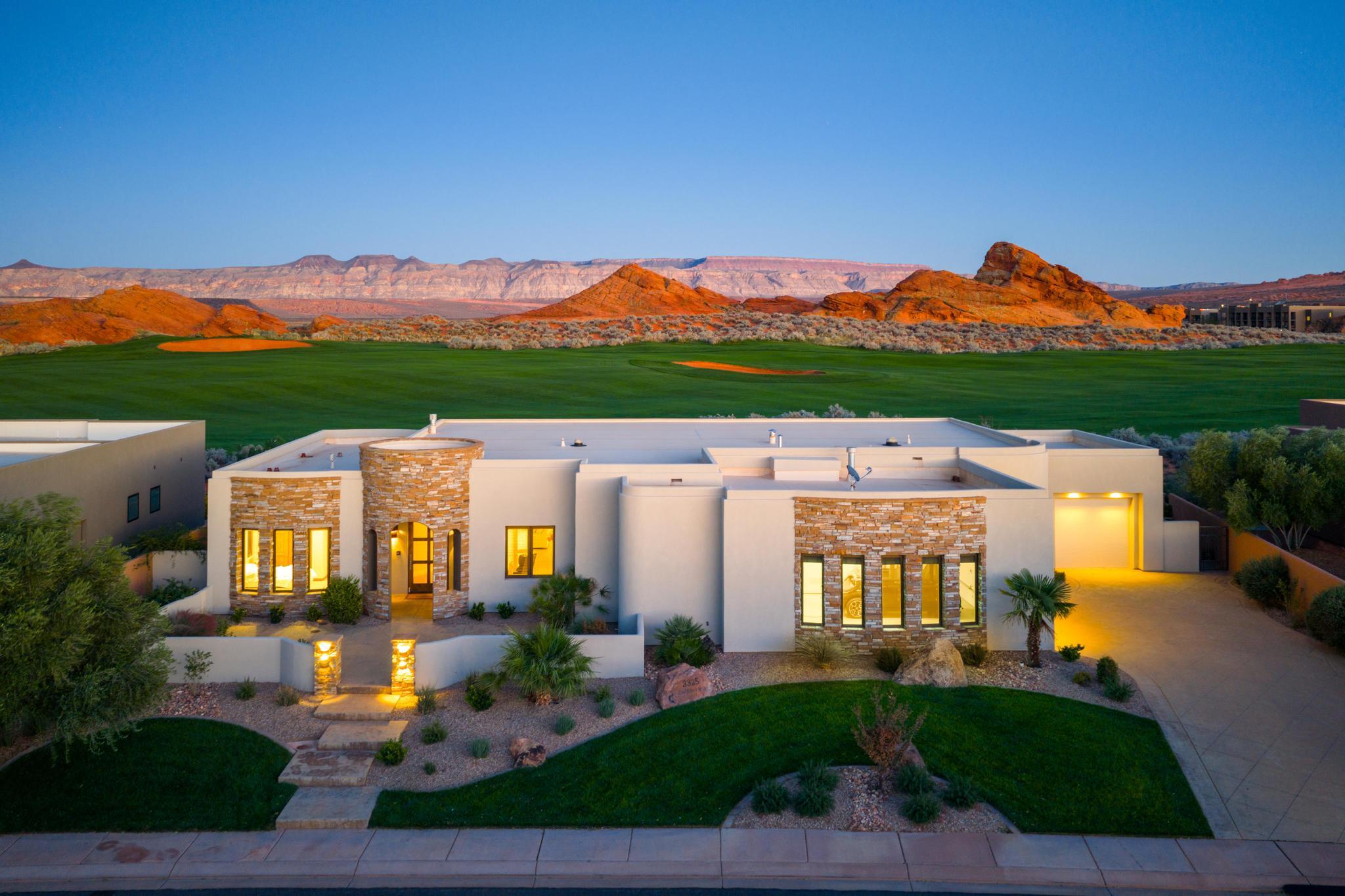 Experience resort-style living in this exquisite 3-bedroom, 2.5-bath custom home perfectly positioned on the 2nd hole of the world-renowned Sand Hollow Golf Course. With breathtaking views of the red rock cliffs and rolling fairways, this modern desert retreat blends luxury, comfort, and design in every detail.

Step inside to an open-concept layout with large picture windows framing the golf course and mountain backdrop. The gourmet kitchen features premium appliances, custom cabinetry, and a spacious island — ideal for entertaining. The living area flows seamlessly to the covered patio, where you can unwind and enjoy vivid desert sunsets.

The elegant primary suite offers a serene escape with a spa-inspired bathroom, walk-in shower, and direct patio access. Two additional bedrooms provide space for family or guests, while the private home theater delivers the ultimate entertainment experience.

Outside, professional desert landscaping complements the home's modern architecture, highlighted by stone accents and warm lighting. A spacious 3-car garage and large driveway offer plenty of room for vehicles, golf carts, and gear.

Located just minutes from Sand Hollow Reservoir, outdoor recreation, and the amenities of Hurricane and St. George, this home captures the essence of Southern Utah living  luxury, leisure, and stunning natural beauty.
