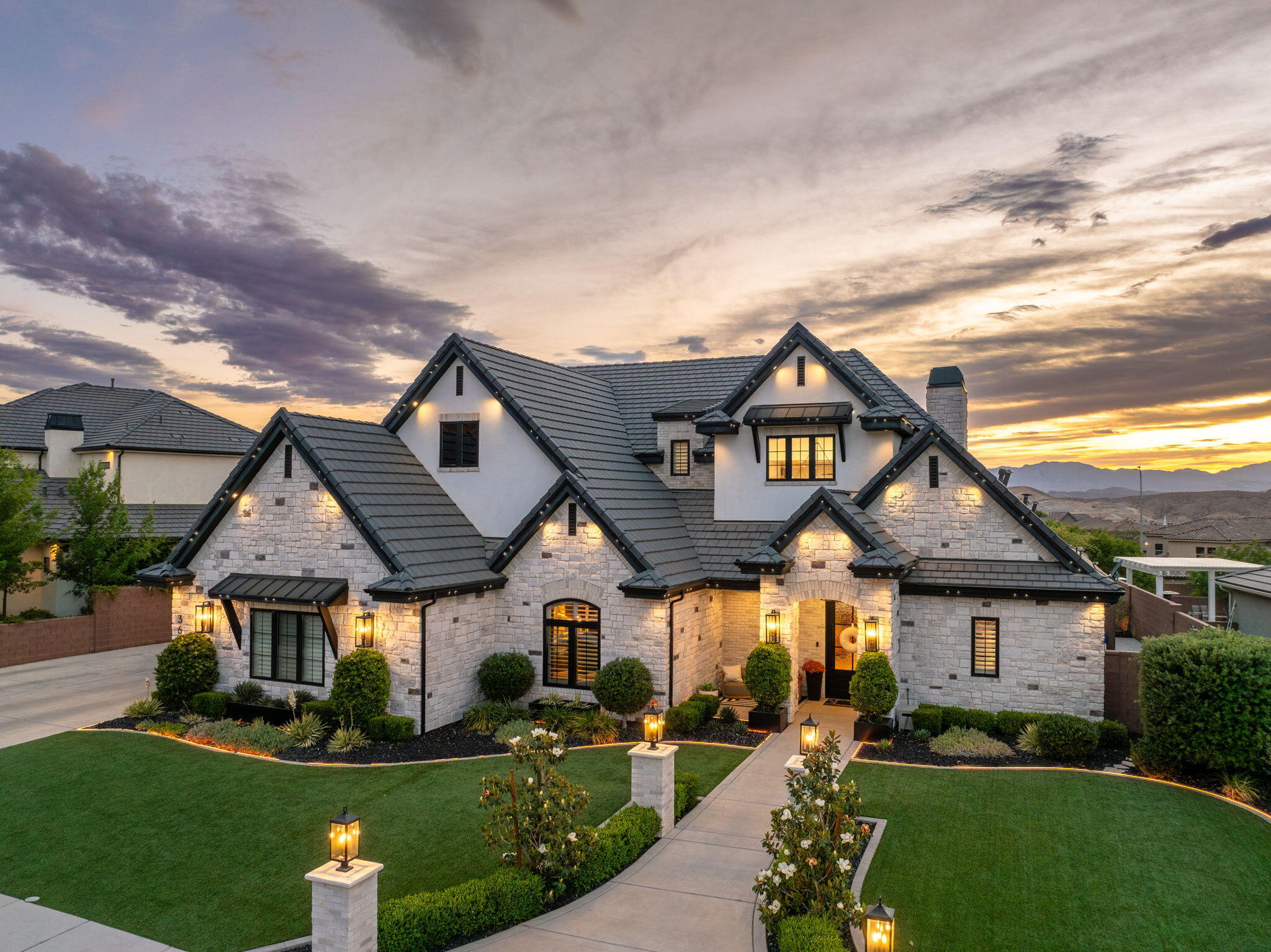 This is not a home, it's an experience. This fully customized Little Valley estate delivers over $800K in upgrades and a rarely seen level of detail. From the moment you walk in, the scale, design, and finishes set the tone. Soaring ceilings, statement fixtures, and perfectly curated ambient lighting are all controlled by a full Control4 smart home system. The kitchen is built for gathering, featuring an oversized island, butler's pantry, high-end appliances, custom cabinetry, and seamless flow into expansive living spaces. The primary suite features vaulted ceilings with exposed black beams creating a striking contrast with the recessed lighting and a chandelier. The spa-inspired bathroom showcases a double vanity with pendant lighting, a freestanding bathtub, and glass doors isolating the large walk-in shower. The spacious walk-in closet offers an organized layout with a central island, multiple drawers, and double-tier hanging rods.  On the main level you can focus on the designated office or work out in the fully equipped home gym with perfect lighting. Upstairs, the fully immersed movie theatre creates a true cinematic experience, including an additional living room and hang out den. Step outside and everything changes. The backyard is a private resort complete with a custom pool, hot tub, waterfall, and rockslide. The outdoor living space built with a modern design, stone pillars, built in counters and accent lighting is next level. It features a fully built-out kitchen with a pizza oven, BBQ, fireplace, integrated heaters, and a TV. Designed for year-round use, put the shades down, turn the fireplace on and enjoy a cozy winter evening. The private sports court is accompanied by high-end artificial turf. Whole-home audio with surround sound carries throughout the interior and exterior of the property, creating a seamless indoor-outdoor experience. No HOA. No compromises. No comparison. This is one of those properties that simply doesn't come around often