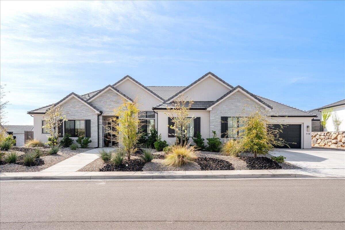 Upscale home in desirable Green Springs neighborhood. Home offers  a blend of modern luxury, space, and a showcase for entertaining guests. Home is designed for those who value entertaining and effortless maintenance. Situated on a large corner lot the home features expansive great room leading into a chef style kitchen. Large center island provides space and seating for gathering.

A dedicated ready to use theater room equipped with furniture, risers, framed projection screen, projector and surround sound (all included). Home features a four car garage with ample space for multiple vehicles, specialized storage, workshop, etc. Improve your putting skills before hitting the course on the professional grade artificial turf nine hole putting green. Positioned for maximum curb appeal and privacy. The lot utilizes modern xeriscaping to ensure exterior remains pristine with minimal effort. Fabulous breathtaking front view of Pine Valley Mountain. 

Close to parks, recreation, shopping, golf course. Don't miss out on this great upscale home. Ready for a new owner. Schedule your showing today!