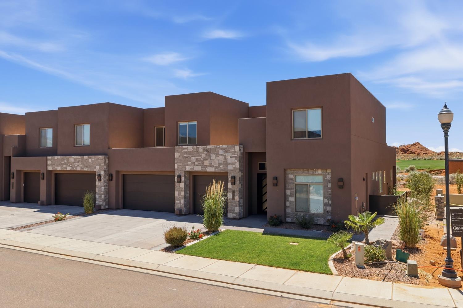 Set on the 5th hole of the award-winning Sand Hollow Resort Golf Course, this contemporary
home in the exclusive TAVA Resort community is a rare find. It is the only home in the community already set up as a short-term rental with Sand Hollow, comes completely turnkey, and is already generating bookings. Whether you are looking for an income-producing property in one of Southern Utah's premier destinations or a vacation home that earns its keep when you're away, this one is ready from day one. Red rock views, world-class golf out the back door, and Sand Hollow Reservoir and the sand dunes just minutes away keep this area in demand year round. The home itself is built for gathering. A dramatic two-story great room fills with natural light and views over the course. Sliding doors open wide to the covered patio, so grilling, dining, and conversation move effortlessly between indoors and out. The open kitchen keeps everyone connected, with an island for casual bites, a larger dining space, and beautiful
designer finishes. The oversized refrigerator and walk-in pantry easily handle a full house, and
the built-in water bottle filling station means guests are always ready to head out. After a day on the course or the water, the main-level primary suite is a retreat unto itself, with a spa-like bathroom and direct patio access. A second main-level suite offers accessible comfort, and four more bedrooms and three full baths upstairs give every guest their own space. The upper landing opens to a balcony spanning the full home, with sweeping views across the 5th hole and Southern Utah's famous sky. Life at TAVA extends well beyond the backyard. The private 104-home enclave gives residents and guests access to two luxury pools, a lazy river, splash pad, clubhouse, pickleball, tennis, and racquetball courts, a fitness center, and an art center. It is the kind of amenity package that keeps a rental calendar full and makes ownership just as rewarding. With a prime golf course location, fully furnished, and already booking, this is a
turnkey opportunity in one of Southern Utah's most beautiful settings.