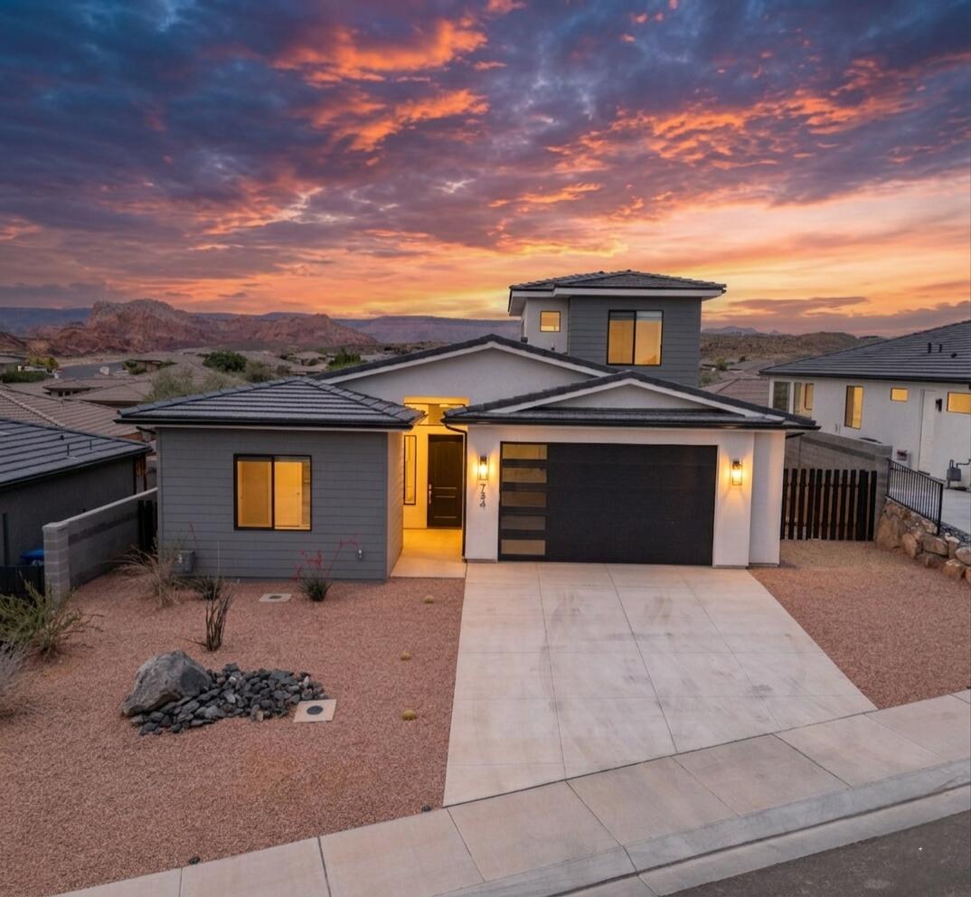 This meticulously maintained home balances modern design with practical functionality in a community with no HOA. The open-concept main floor is anchored by 10 ceilings that vault up to 12 feet and high-quality, durable 20 MIL LVP flooring, making the living space feel both expansive and durable. The gourmet kitchen is built for those who love to cook, featuring a premium GE stainless steel gas appliance package, staggered shaker cabinetry with soft-close doors and drawers, and sleek quartz surfaces accented by a brick-patterned backsplash.

 The primary suite is conveniently located on the main level and features a custom zero-entry tile shower with dual controls and frameless obscure glass. 

Upstairs, the functional loft provides a flexible secondary living space that leads to a covered deck with clear mountain views that will take your breathe away. 

Extra High-end details are found throughout, including modern black window frames, Moen plumbing fixtures, a tankless water heater with a built-in recirc pump, and a saltless water softener system. The exterior is equally impressive, offering a large rear concrete patio and an extra wide garage finished with insulated doors and a custom grey epoxy floor. 

This home offers the benefits of custom-level quality and thoughtful upgrades in a prime location. Schedule a tour to see these finishes in person.