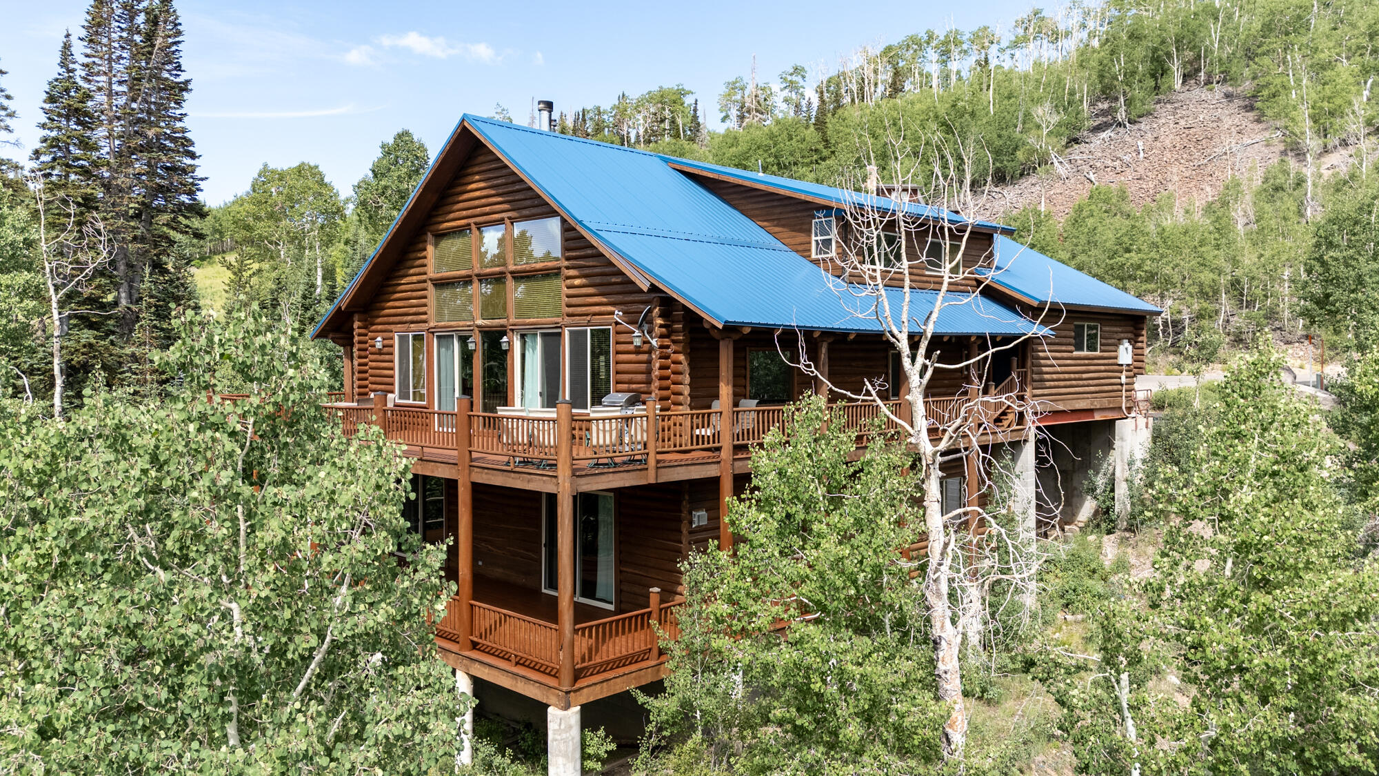 Experience mountain living at its finest in this stunning 4,000 sq. ft. log cabin located across from Giant Steps Ski Lodge in Brian Head, Utah. Featuring 3 private bedrooms plus a large loft bedroom and 4 baths, this home offers vaulted ceilings, a dramatic rock 2 fireplaces in the great room, and a thoughtfully designed open layout. The walkout basement includes a game room and wet bar, perfect for entertaining. Step outside to two expansive 1,050 sq. ft. decks--newly stained--offering breathtaking forest and ski area views. Watch the annual Torchlight Parade and fireworks from the comfort of your home. Set on a quiet cul-de-sac with a large driveway, the property also benefits from recent updates including a new roof, windows, and luxury vinyl plank floors. Enjoy the mountain charm! Sold completely furnished with a few minor exceptions for a few electronics and items in garage 2.