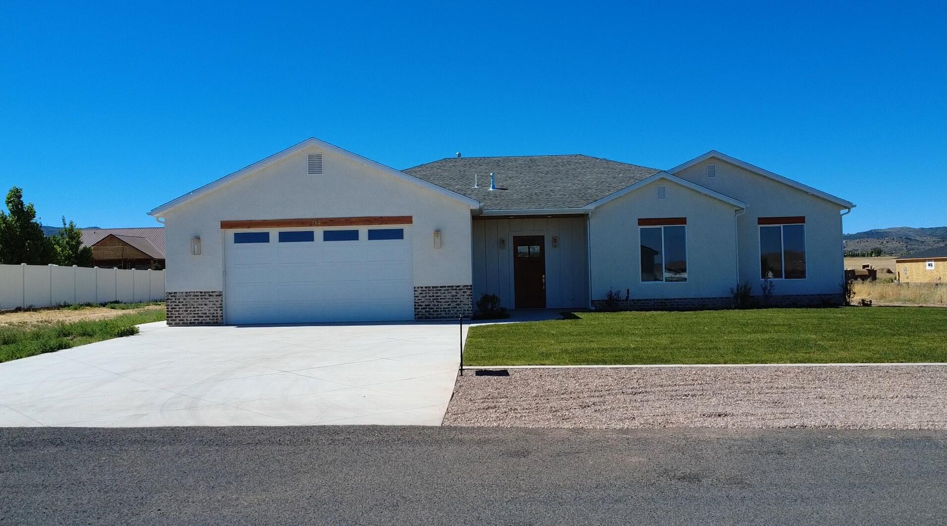 Brand new 2026 build in Enterprise! This 2,657 sq ft home offers 4 bedrooms, 3 full baths, and an oversized 2-car garage on a 0.50 acre lot. at the end of a cul-de-sac. No HOA. Designed with upgrades throughout: tall ceilings and doors, quartz countertops, custom cabinetry, large pantry, luxury laminate flooring, upgraded carpet/pad, and spray foam insulation for efficiency. The open living, dining, and kitchen area features an 8-burner ILVE gas range with electric oven, stunning hood, and a 6' side-by-side commercial-style fridge/freezer. Spacious primary suite with tiled shower and bath, plus a 2nd bedroom with private ensuite. Large laundry with sink, water softener, EV charger stub, shed/shop power stub, wired for sprinklers. Landscaping ready for your vision. 40 minutes to St. George or Cedar City.