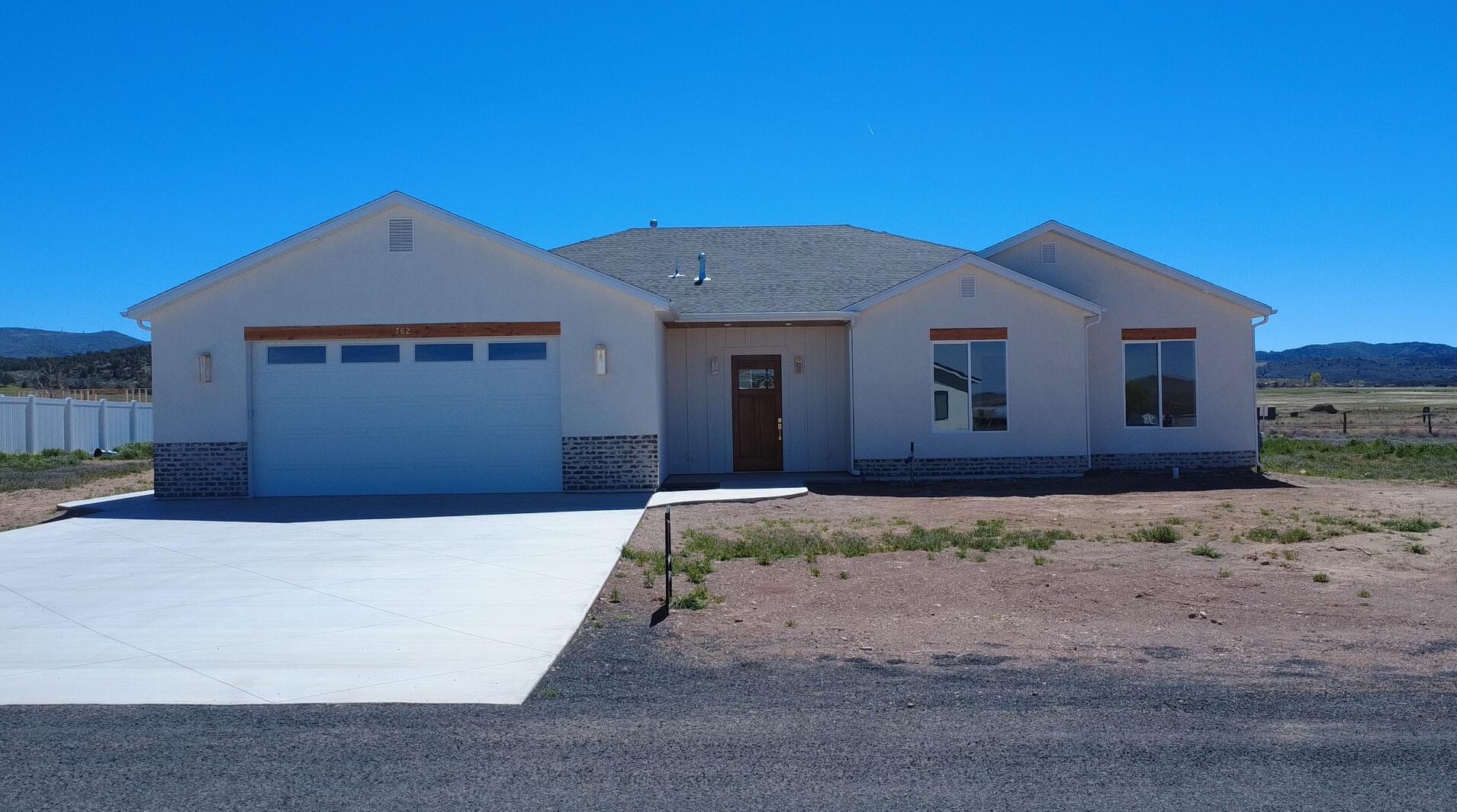 Brand new 2026 build in Enterprise! This 2,657 sq ft home offers 4 bedrooms, 3 full baths, and an oversized 2-car garage on a 0.50 acre lot. at the end of a cul-de-sac. No HOA. Designed with upgrades throughout: tall ceilings and doors, quartz countertops, custom cabinetry, large pantry, luxury laminate flooring, upgraded carpet/pad, and spray foam insulation for efficiency. The open living, dining, and kitchen area features an 8-burner ILVE gas range with electric oven, stunning hood, and a 6' side-by-side commercial-style fridge/freezer. Spacious primary suite with tiled shower and bath, plus a 2nd bedroom with private ensuite. Large laundry with sink, water softener, EV charger stub, shed/shop power stub, wired for sprinklers. Landscaping ready for your vision. 40 minutes to St. George or Cedar City.