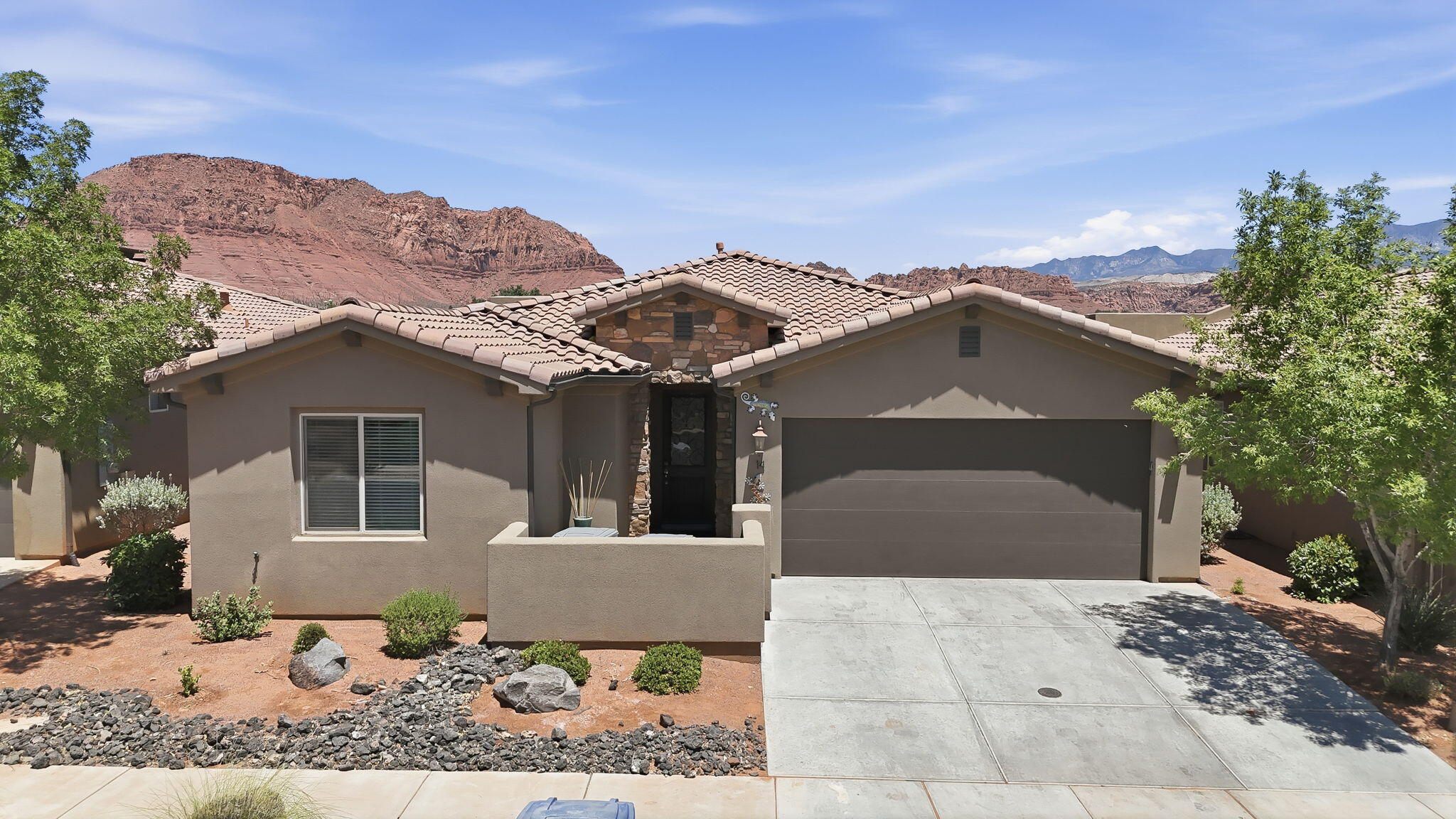 Exceptional opportunity to own a high-performing VACATION RENTAL with an excellent rental history, offered fully furnished and completely turnkey! Thoughtfully designed for comfort and entertaining, this beautifully maintained home features spacious bedrooms, premium tile throughout, granite countertops, and beautifully tiled showers. The large chef-inspired kitchen flows seamlessly into an oversized dining area, creating the perfect space for gathering, while four washers and dryers provide added convenience for owners and guests alike. The expansive basement is ideal for entertaining, complete with foosball and gaming systems, while the private rooftop patio showcases breathtaking views and a private hot tub, the perfect place to unwind after a day of exploring Southern Utah. The luxurious primary suite offers a spacious ensuite bathroom with dual vanities, creating a relaxing retreat. Residents and guests enjoy world-class resort amenities including a clubhouse, fitness center, pickleball courts, and two spectacular swimming locations featuring a water park, lazy river, multiple pools, and hot tubs. Ideally located just minutes from Tuacahn, Snow Canyon, and Harmon's, this exceptional property offers the perfect blend of luxury, recreation, and outstanding investment potential. Buyer to verify all information, deemed reliable, however buyer to verify all info including utilities, rental restrictions, and HOA information if applicable.