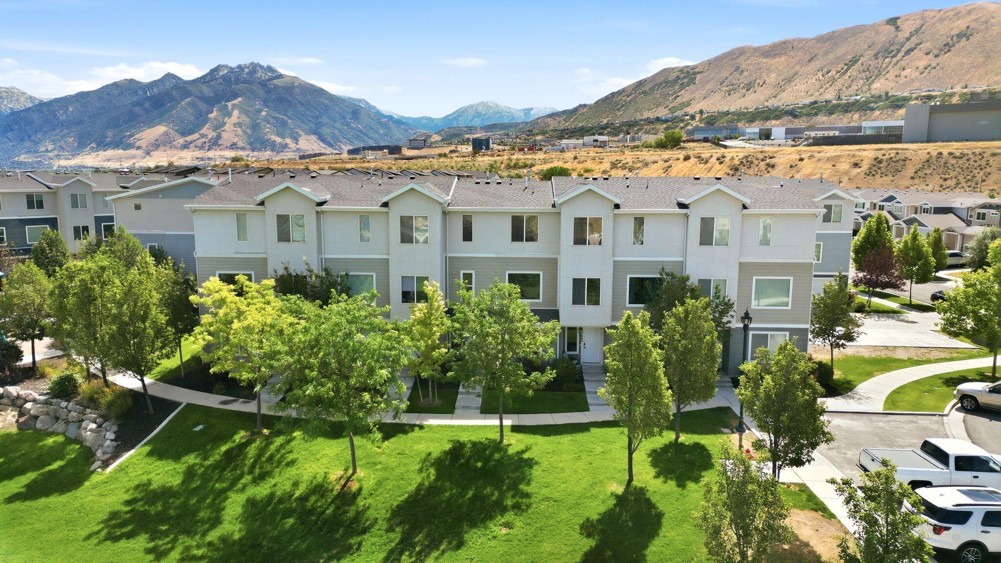 Experience stylish, low-maintenance living in this beautifully appointed end-unit townhome tucked away at the end of a quiet cul-de-sac with convenient access to I-15. Designed with an open-concept floor plan and 9-foot ceilings, the main level offers a bright, inviting space that's perfect for both everyday living and entertaining. The kitchen showcases quartzite countertops, a striking marble backsplash, a spacious island, and abundant cabinetry. The adjoining living area features a sleek fireplace that creates a warm, modern focal point. Upstairs, the spacious primary suite includes a large walk-in shower and comfortable retreat. Recent upgrades include brand-new carpet, while additional features such as a water softener, and an attached 2-car garage add everyday convenience. Move-in ready and ideally located, this home offers the perfect blend of style, functionality, and accessibility.