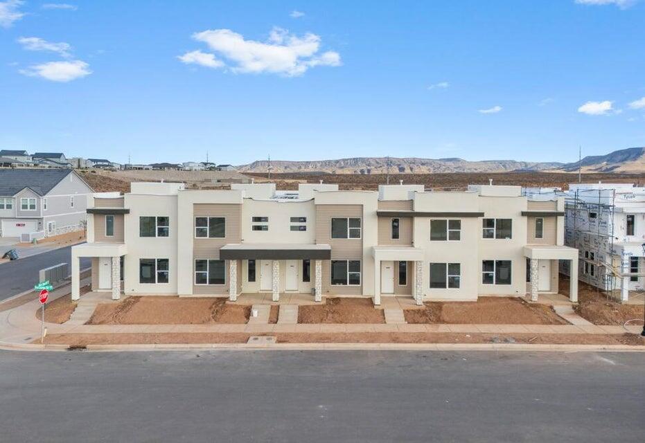 NEW TOWNHOME UNIT! You won't want to miss this opportunity! This spacious townhome features an open layout on the main level. The kitchen is finished with quality white cabinets with sleek white quartz countertop. Upstairs has a nice loft space and the bedrooms have generous closets. Primary bathroom has beautiful luxurious shower with tile surround and euro glass. This home has access to the amazing Desert Color amenities including the 2.5 acre lagoon, pool/hot tub, and pickleball courts. This home is not nightly rental approved. Pictures of home are of the model home which is an end unit. Please call Matt Shelton with any questions. Thanks!