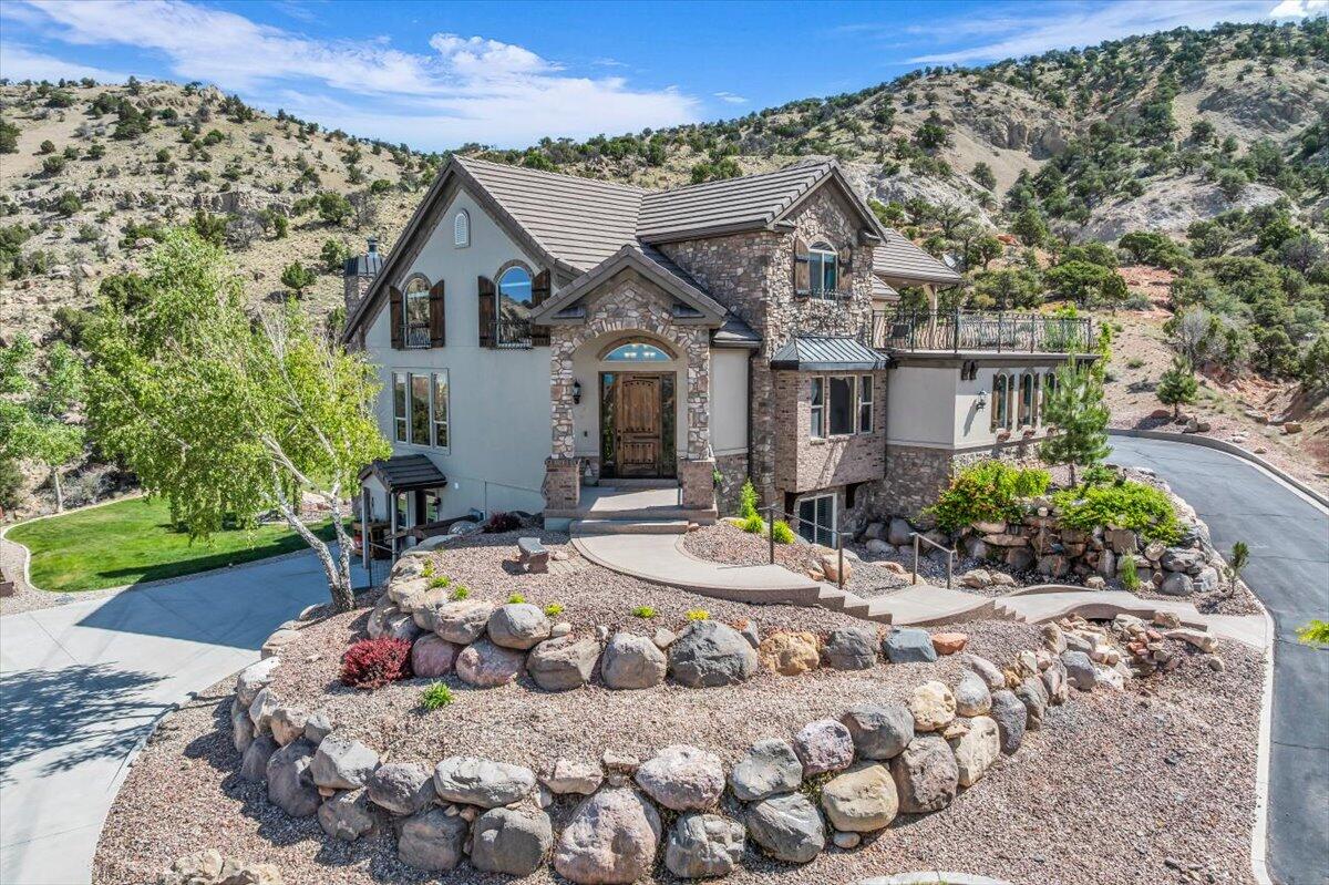 This one-of-a-kind 7 bed, 4.5 bath canyon retreat blends exceptional privacy, sweeping red rock views, and timeless Tuscan-inspired design—all tucked away within city limits. With 5,901 sq ft of immaculate, meticulously maintained living space, the home features a spacious main-floor master suite, multiple gathering areas, generous storage, and thoughtfully designed interior finishes throughout. The beautifully landscaped backyard includes a sun deck oriented to capture the scenery, plus plenty of parking for guests, toys, or trailers. Although it's right in town, the property feels completely secluded—offering the rare combination of mountain serenity and everyday convenience. Inside, the thoughtful layout includes a spacious main-level primary suite, inviting living areas filled with natural light, and elegant finishes throughout. Step out onto the elevated sun deck to enjoy peaceful mornings or vibrant sunsets, or gather in the beautifully landscaped backyard that blends seamlessly with the surrounding scenery. An oversized driveway provides ample room for guests, recreational vehicles, or extra parking.

One of the home's standout features is the fully finished walkout basementcomplete with a second kitchen, private laundry, and separate entrance. Whether you're accommodating extended family, welcoming long-term visitors, or exploring rental or Airbnb potential, this flexible space adds incredible value and opportunity.

Best of all, this home offers unmatched access to the outdoors. From world-class skiing at Brian Head to iconic national parks like Zion and Bryce Canyon, Southern Utah's natural wonders are right at your fingertips. Hiking, biking, and off-road trails begin just beyond your doorstep.

Whether you're looking for a peaceful primary residence, a mountain-view retreat, or a property with built-in income potential, this Cedar City gem delivers on every level.

*HOA dues cover snow removal