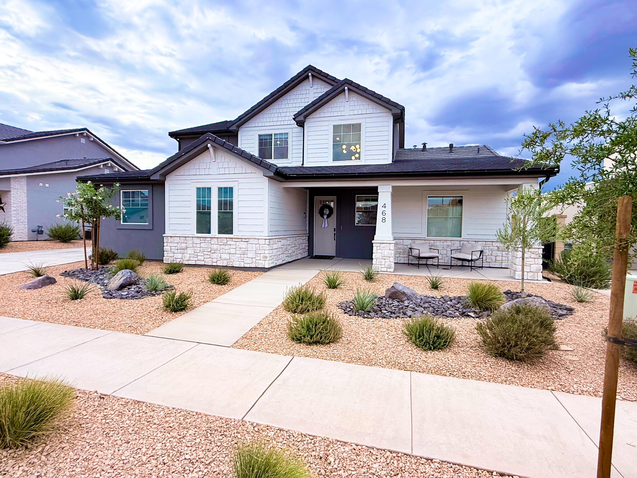 Perfectly located in the highly desirable community of Desert Color, this beautiful home offers the perfect blend of solid builder quality and thoughtful owner enhancements--complete with stunning views of Southern Utah's red rocks. While neighboring Visionary Homes boast excellent construction with robust 2x6 exterior framing, this residence stands out thanks to premium builder selections and high-value upgrades completed after construction. For a buyer, this means skipping the post-closing projects, delays, and out-of-pocket expenses to enjoy a completely finished, turnkey home from day one.
The open-concept layout is designed for seamless living and effortless entertaining. In the kitchen, custom white oak cabinetry runs to the ceiling, complemented by soft-close hardware, pull-out shelving, a smart fridge, a farmhouse sink, and a commercial-grade 30'' Forno gas range. An extra-large upgraded sliding glass door connects the kitchen to the extended concrete covered patio, private synthetic turf yard, and xeriscaping. Indoors, the home is elevated by eight-foot doors, modern black hardware, entry chandeliers, a cozy living room fireplace, and hidden in-wall TV wiring.
The thoughtful split floor plan includes a primary suite oasis featuring a brass shower system with three shower heads (including a waterfall head) and a private stackable washer and dryer tucked into a master bath closet. Upstairs, a versatile loft selection offers the perfect second hangout space, playroom, or media lounge, located right alongside a spacious second laundry room with dedicated space to add a utility sink. Car and hobby enthusiasts will appreciate the extra-deep, fully insulated three-car garage, complete with durable epoxy flooring, custom storage, a highly convenient utility sink, and a 220V electric vehicle charging station.
As a resident of Desert Color, your lifestyle is further elevated by incredible local growth and top-tier community perks. Lightning-fast fiber optic internet is fully included, and you are positioned just moments from all the exciting new shopping, dining, and entertainment coming to the immediate area--including the brand-new Costco right on Desert Color Parkway and the highly anticipated In-N-Out Burger. Located just one block from a local park and pool, you also have premier access to Desert Color's signature 2.5-acre white-sand lagoon, resort pool, and cabanas, delivering the ultimate Southern Utah lifestyle.