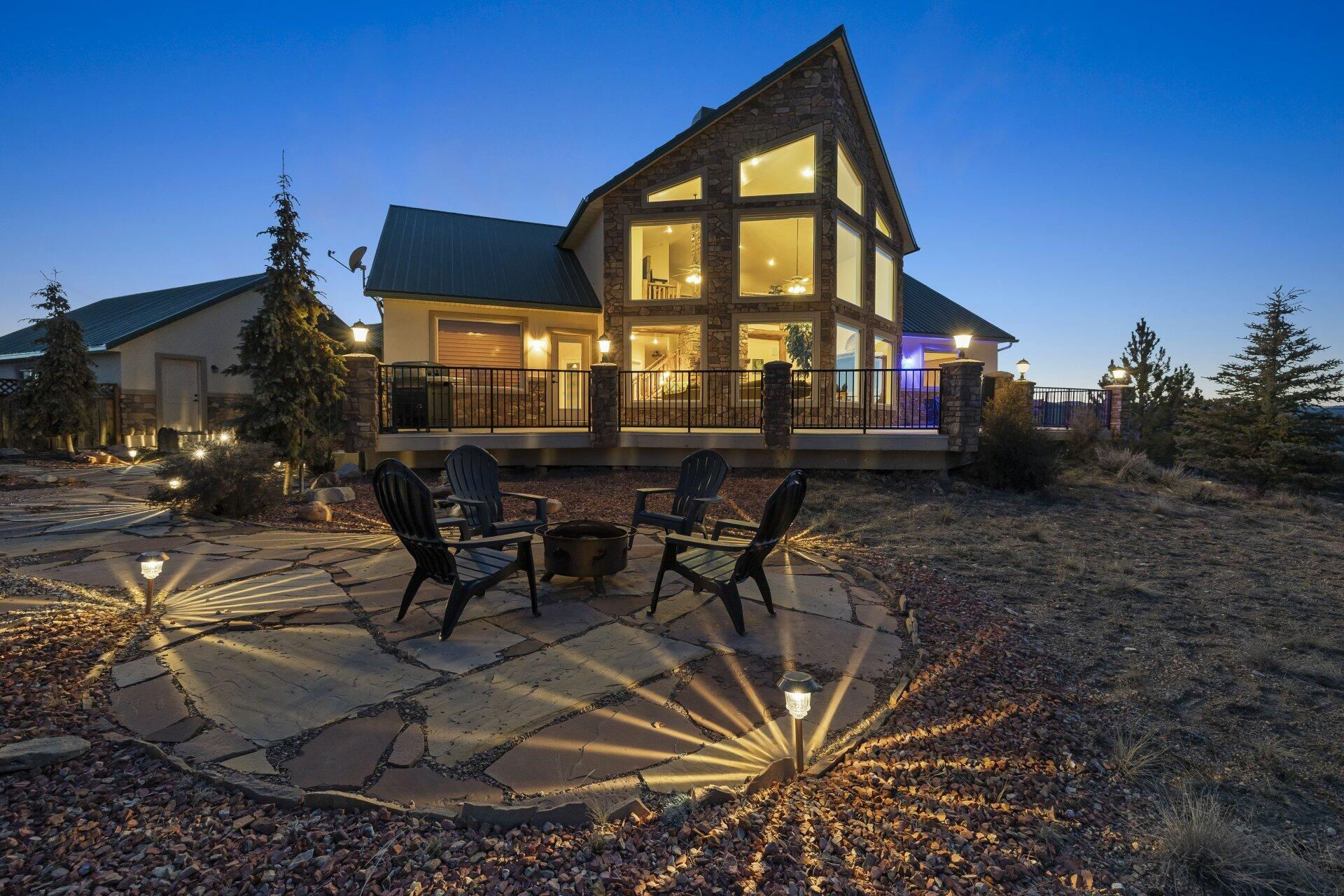 Perched on 2.43 private hilltop acres, this exceptional 2,815 sq ft luxury estate features 3 bedrooms, 2.5 bathrooms, and breathtaking panoramic views of Red Canyon and the Paunsaugunt Plateau. Floor-to-ceiling windows flood the main living area with natural light and perfectly frame the stunning scenery. A dramatic rock fireplace with wood-burning insert anchors the living room, creating a warm, inviting space to unwind after exploring Southern Utah's outdoors.

The spacious chef's kitchen offers generous prep space plus a new refrigerator and garbage disposal--ideal for entertaining and everyday living. A versatile loft overlooks the main level and makes a perfect home office, reading nook, or additional family space.

Designed for comfort and efficiency, the home includes two water heaters, water softener, whole-house water filtration, reverse osmosis, and a new air conditioner.

Step outside to a peaceful patio and deck surrounded by mountain views, along with a greenhouse and storage shed for gardening and projects.

Need space for vehicles or hobbies? The property delivers with a 1,000 sq ft detached garage, a 1,600 sq ft shop with three overhead doors, and a blacktopped driveway extending to the shop and additional garage.

Adventure starts at your doorstep with nearby ATV trails and excellent fishing at Panguitch Lake and the Sevier River. Located just 28 minutes from Bryce Canyon National Park and 55 minutes from Zion National Park, you'll enjoy easy access to two of Utah's most iconic destinations.

Frequent wildlife sightings--including deer, elk, coyotes, wild turkeys, and eagles--complete the immersive mountain living experience.

A rare opportunity to own a private luxury retreat with acreage, views, and unmatched outdoor access. This home can be used as a nightly rental. Furniture and gym equipment packages available.