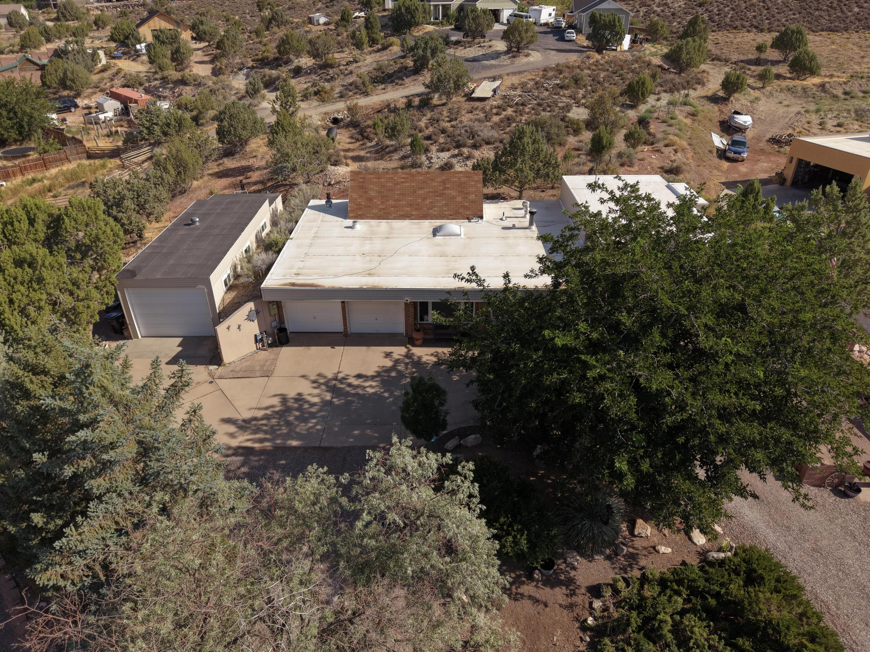 Tucked away in the peaceful community of Diamond Valley, this solid home sits on nearly a full acre with mountain views, mature trees, and room to breathe. Inside, the kitchen flows into a bright dining area with vaulted ceilings and skylights that flood the space with natural light. The cozy living room features a wood-burning fireplace and built-in shelving, while the upper level primary suite includes a private balcony and a separate laundry room with storage and shelving. A spacious covered patio and courtyard make the backyard ideal for outdoor living and entertaining. The detached 667 sq/ft garage offers room for vehicles, storage, or a workshop, in addition to the 2-car attached garage. With no HOA and a relaxed rural feel just minutes from St. George amenities, this one offers the best of both worlds.