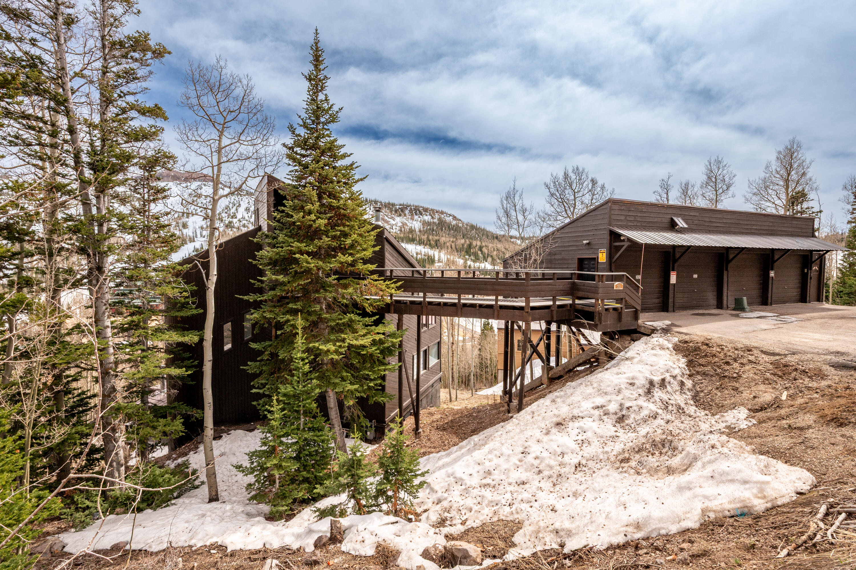 Located in Brian Head, this 3,345 sq ft mountain home offers a distinctive setting with year-round access and expansive, unobstructed views. Designed to take full advantage of its surroundings, the home features several outdoor decks that provide multiple spaces to gather, unwind, and enjoy the scenery from different angles. Inside, the home has been expanded and updated over time. The floor plan includes four separate sleeping areas, including a primary suite with its own fireplace and private bathroom with a Jacuzzi tub. Additional highlights include a secondary bedroom with a fireplace, a main living area with a gas fireplace, and an upper-level loft or office space. The kitchen is equipped with modern appliances and connects easily to the main living areas, making the space practical for both everyday use and entertaining. The lower level adds flexibility with a second family or media room, bunk space, a laundry area, and additional storage.

A standout feature of the home is the enclosed solarium, which includes a hot tub, sauna, and space for a small workout area--all oriented to capture the surrounding views. Recent upgrades include refreshed finishes, updated lighting, refinished hardwood floors, and improved safety systems. The home also includes two water heaters, adding convenience for larger groups.


Set along the mountainside and accessed by a 50-foot bridge, the property looks out over Brian Head Resort, Bristlecone Pond, and the valley below, all while being just a short drive from the main ski areas. This property offers a well-rounded mountain retreat in a highly scenic location.

Square footage breakdown.
Level 1; Entrance office: 350sqft.
Level 2; Living Room and stairs: 784sqft
Level 3; Bedrooms and stairs: 784sqft
Level 4; Basement: 784sqft
Level 5; Jacuzzi room: 410sqft + Bedroom/storage: 233sqft
Buyer to verify square footage.