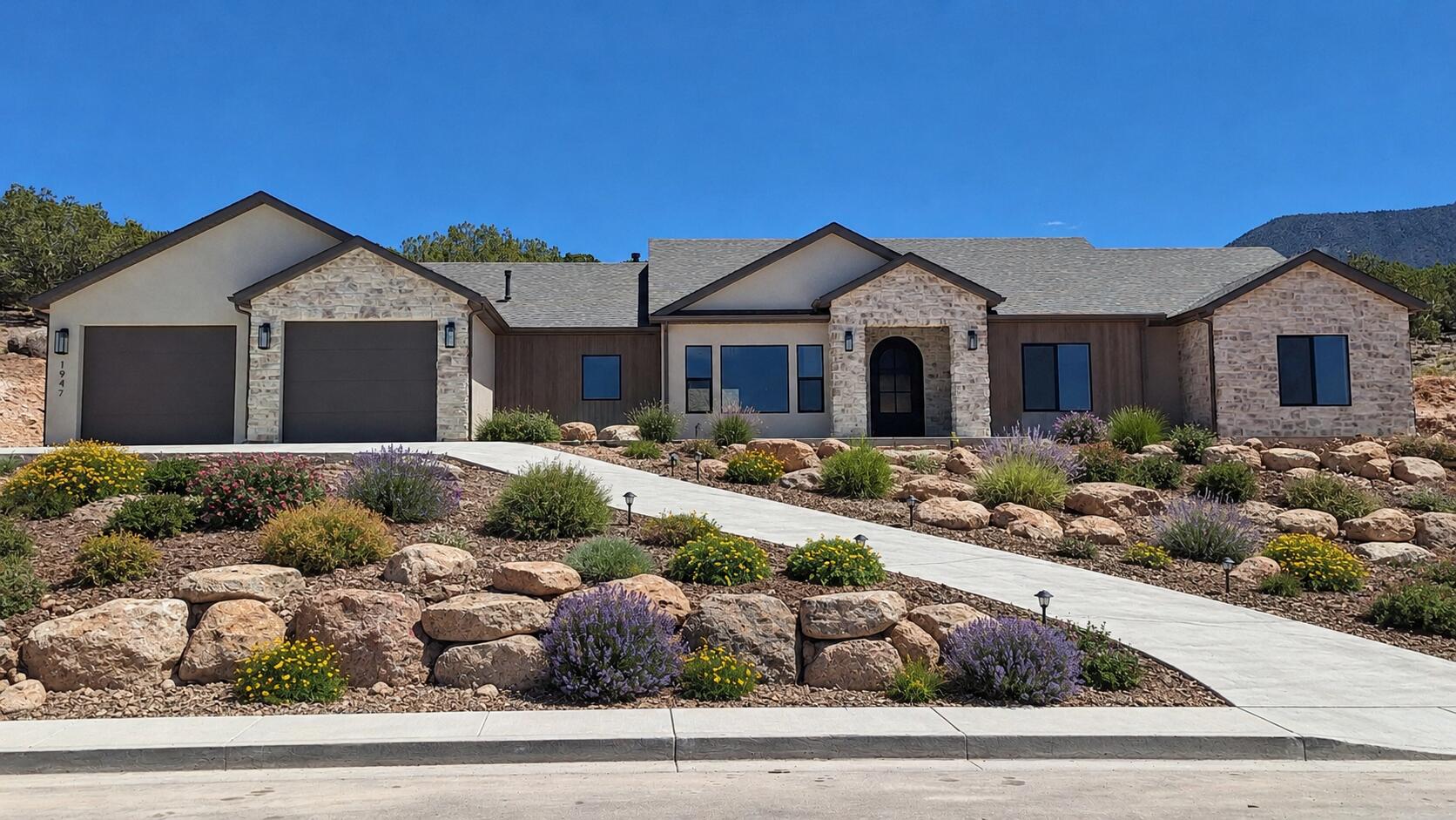 New construction home with thoughtfully designed architecture and elevated finishes throughout. A stunning rock entry welcomes you into a full rock foyer that creates an impressive first impression. Inside, the beautiful open living room featuring a fireplace with elegant arched accents and a dramatic sliding glass door wall that fills the space with natural light and opens to the outdoor living area. The spacious dining room is perfectly positioned to capture natural light and flows seamlessly into the gourmet kitchen, complete with a wet bar and butler's pantry--ideal for entertaining. The private master suite offers a peaceful retreat with a spa-like bathroom and generous closet space, while closet systems throughout the home provide both function and organization. This thoughtfully designed floor plan offers 4 bedrooms and 2.5 bathrooms, providing space for both everyday living and guests. Enjoy outdoor living on the covered, private back patio, perfect for relaxing or entertaining. The oversized garage includes a rear garage door, offering convenient access for toys, recreational vehicles, or additional storage.